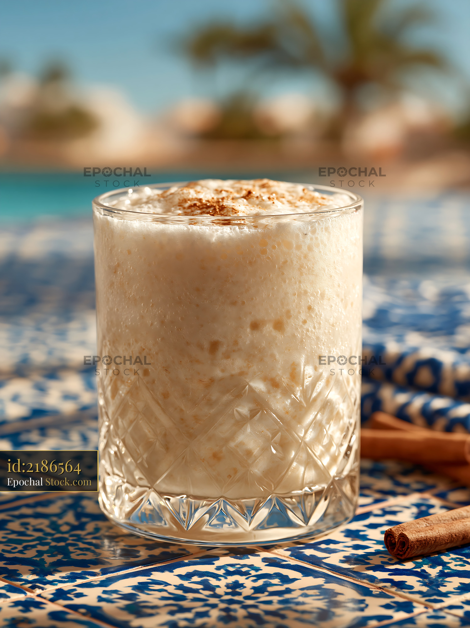 Cloudberry cream milkshake in a crystal glass on a tiled table - stock photo