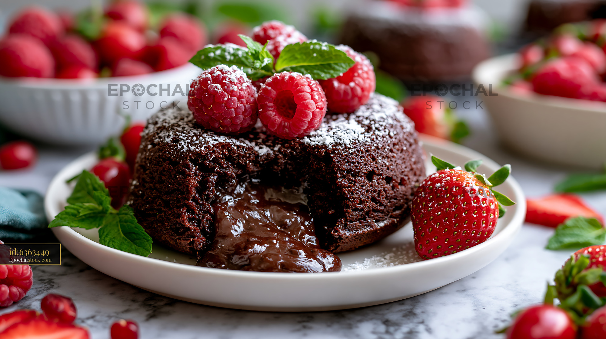 Watermarked full-resolution preview of Chocolate cake with melted center and fresh berries on a plate