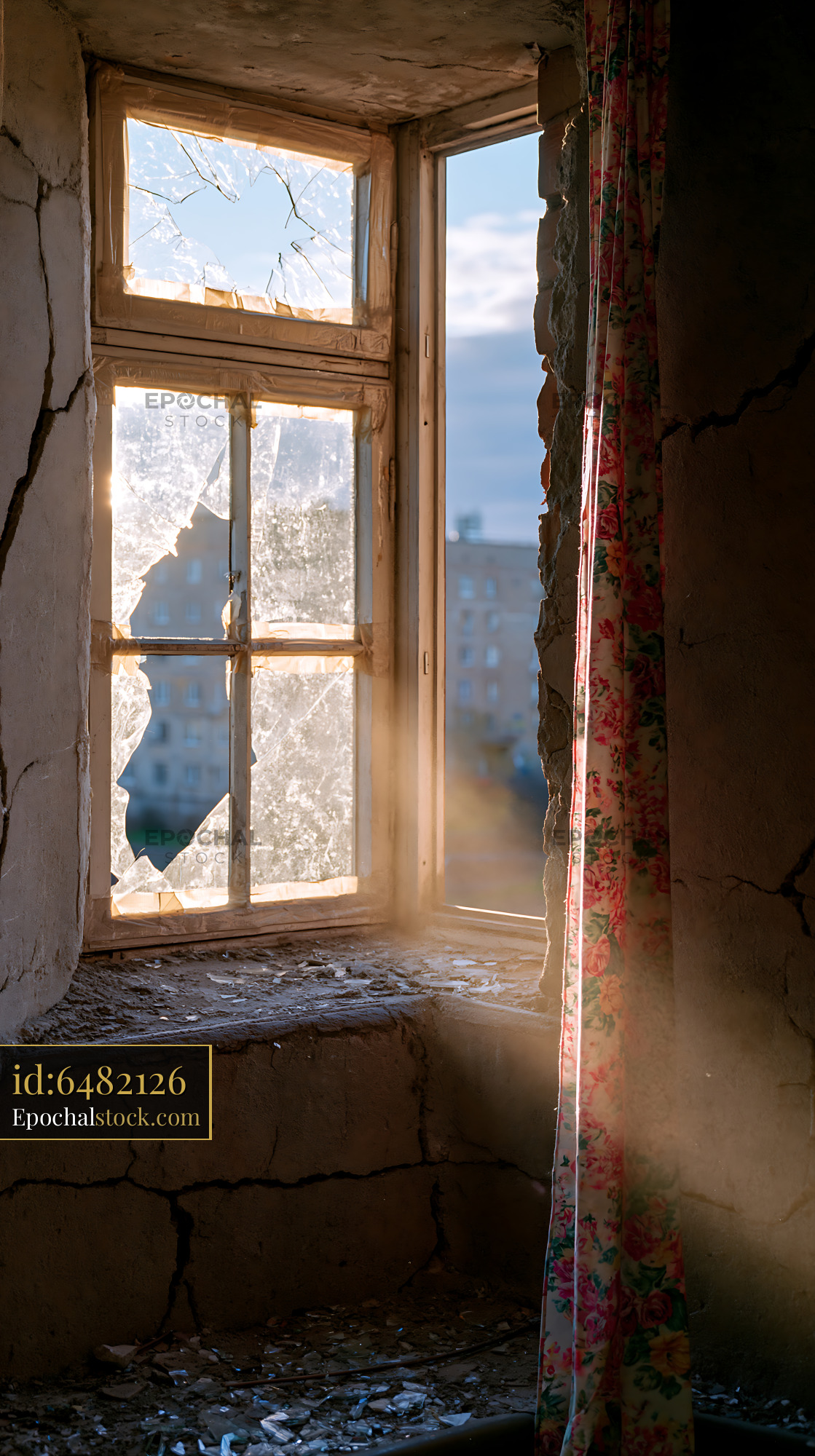 Watermarked full-resolution preview of Light streaming through broken window in abandoned building