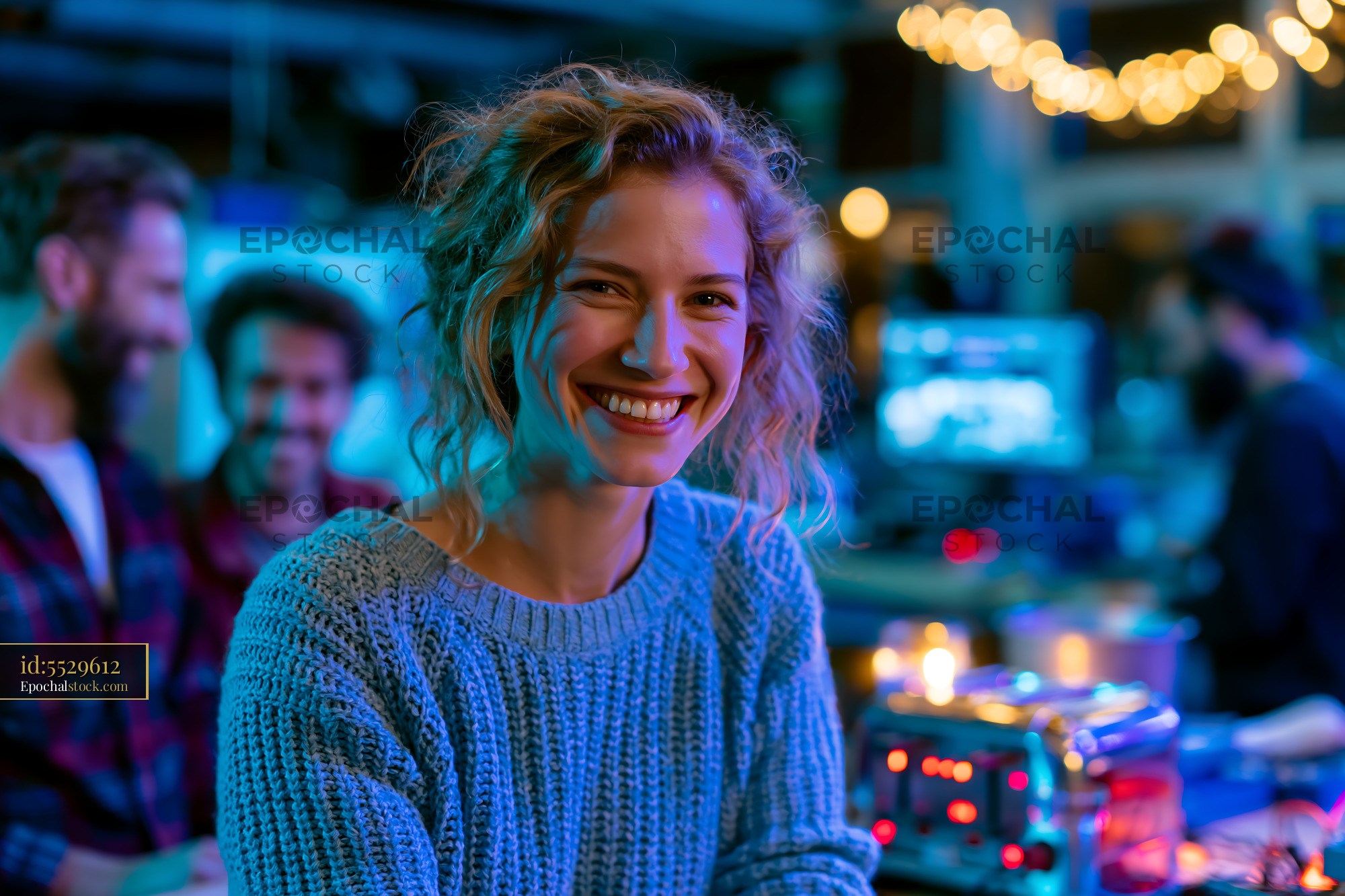Watermarked full-resolution preview of Smiling woman in a cozy indoor space with friends