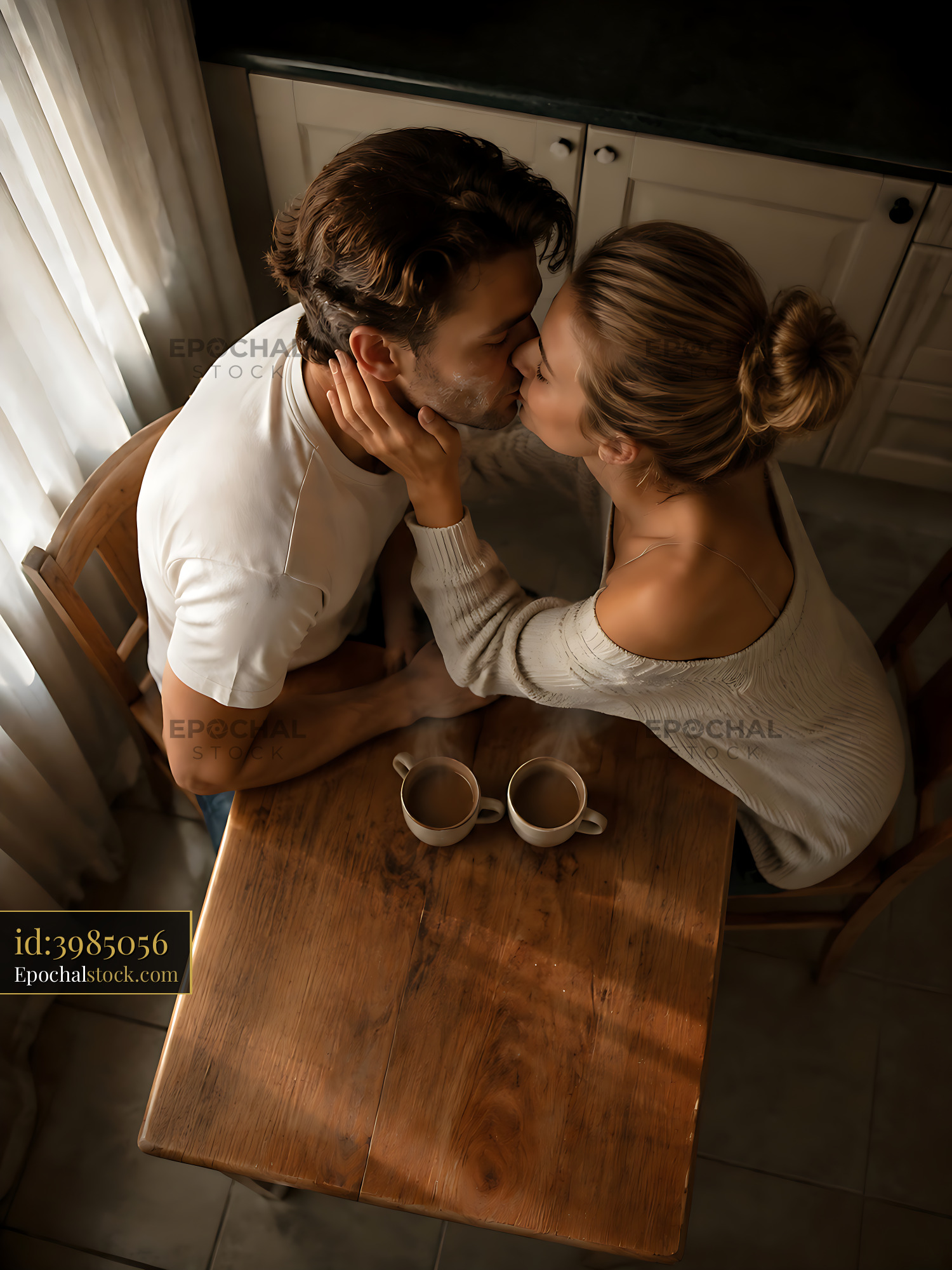 Couple Sharing a Kiss While Enjoying Coffee at Home Table - stock photo