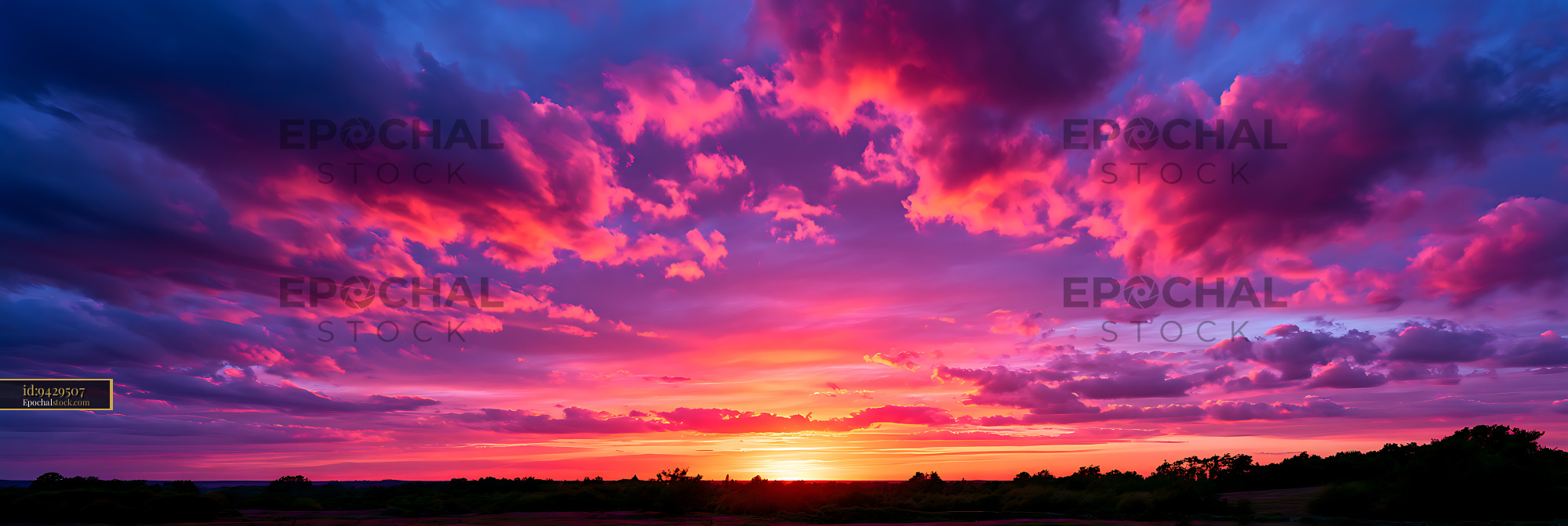 Watermarked full-resolution preview of Colorful sunset clouds above a silhouetted landscape
