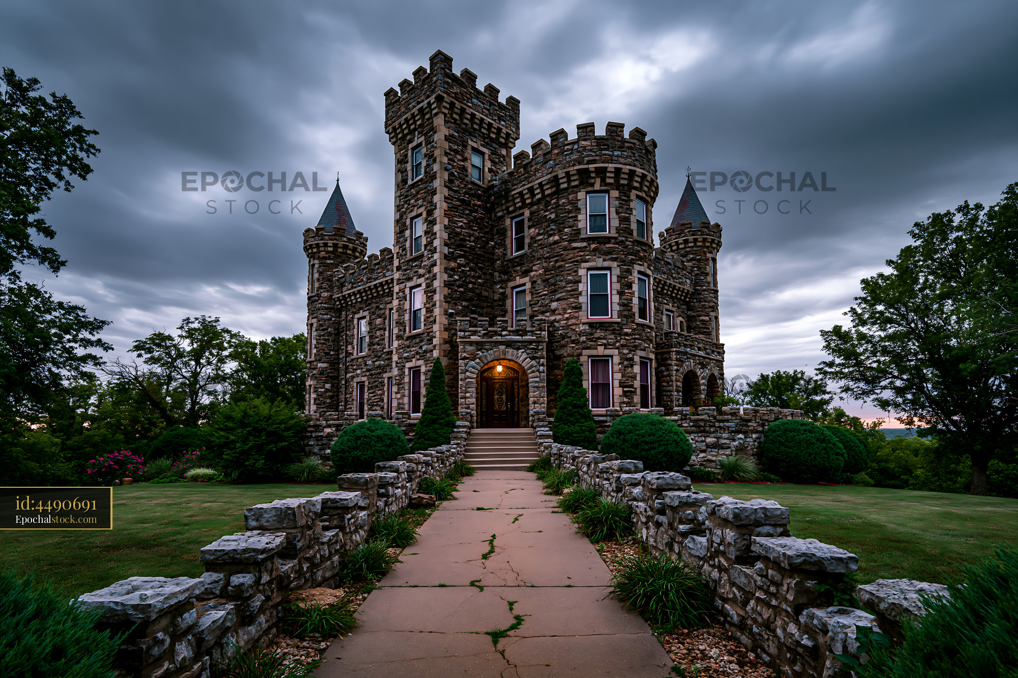Watermarked full-resolution preview of Historic stone castle under cloudy sky in a green landscape