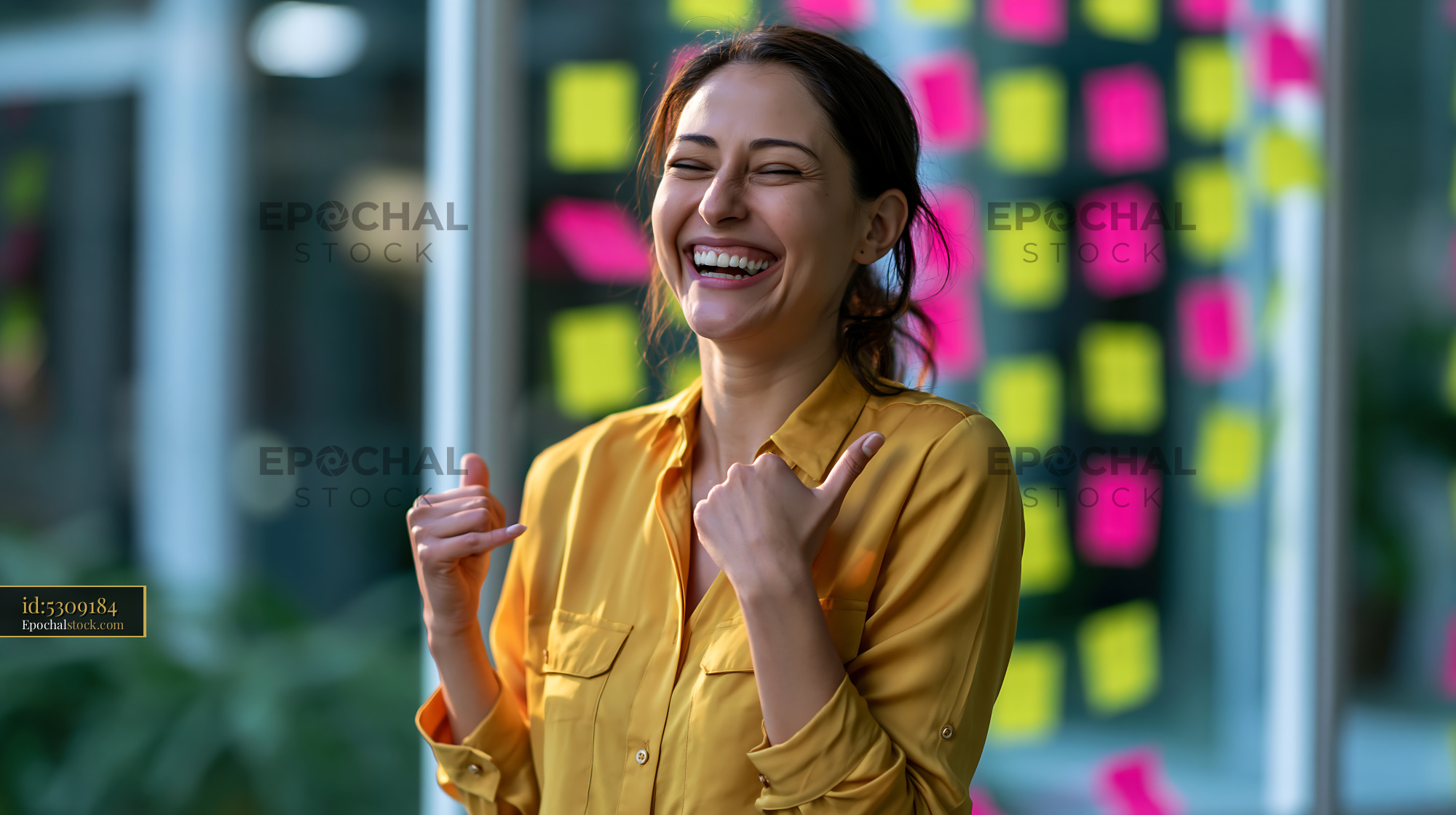 Watermarked full-resolution preview of Woman smiling in an office with colorful sticky notes on the wall