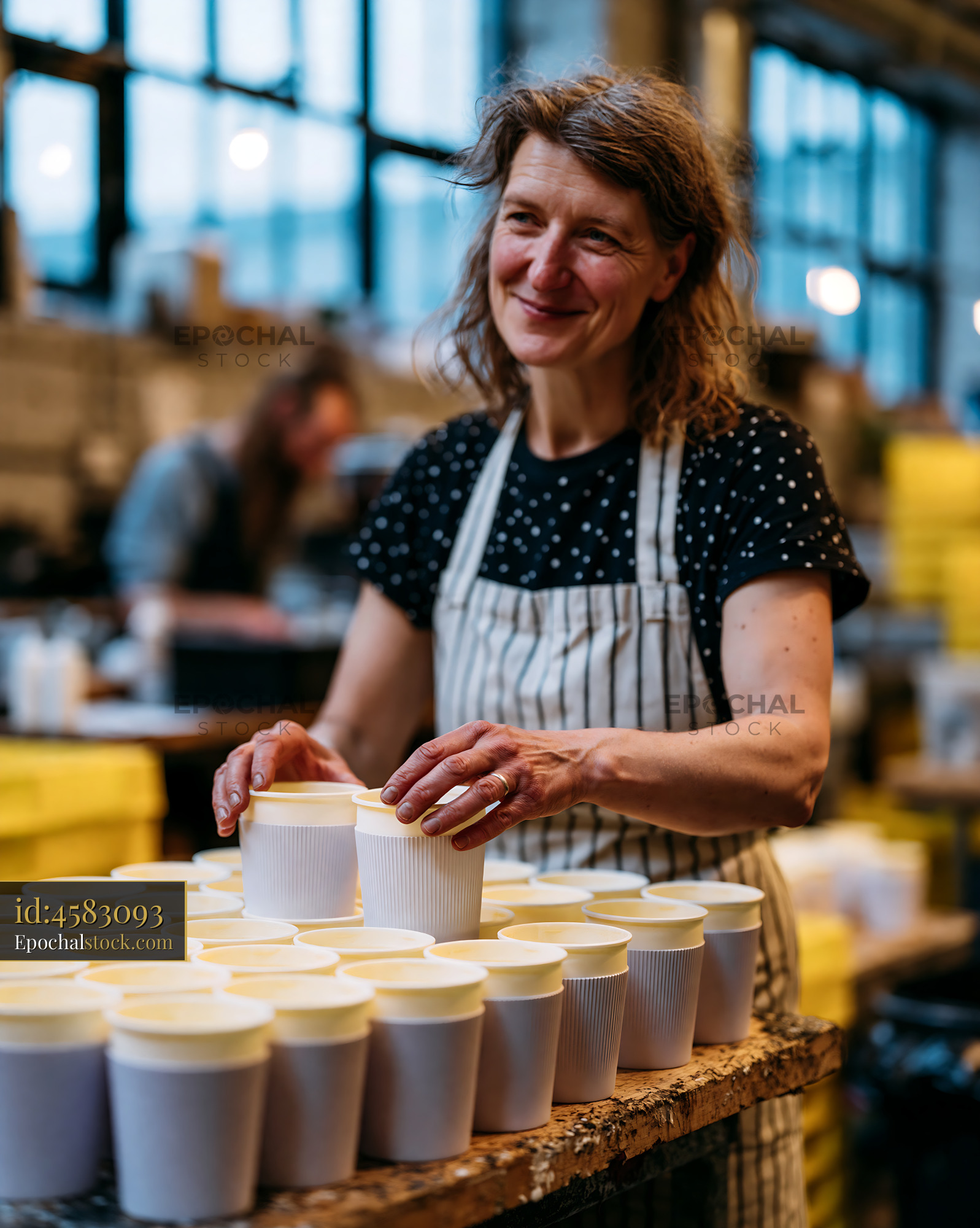 Watermarked full-resolution preview of Barista arranging cups in a coffee shop setting