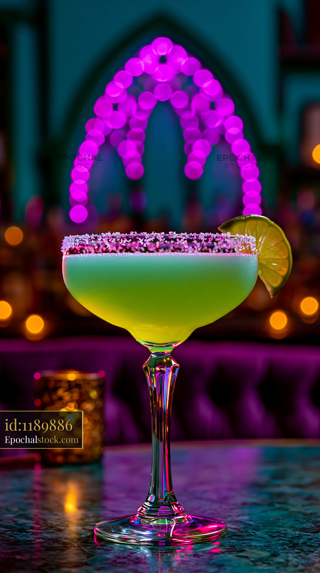 Watermarked full-resolution preview of Colorful cocktail with lime on bar counter at night