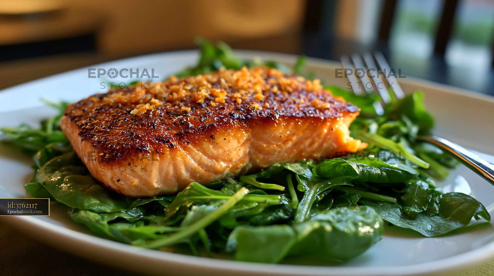 Watermarked full-resolution preview of Salmon fillet served on a bed of fresh spinach leaves