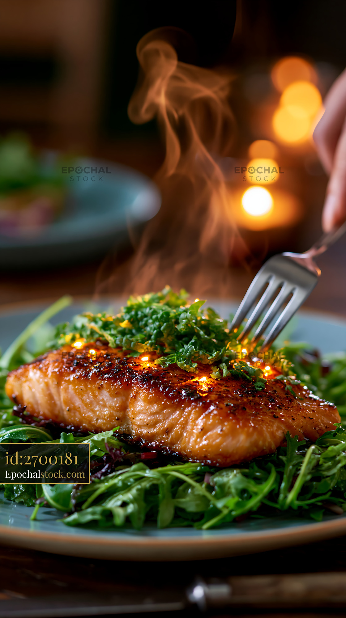 Watermarked full-resolution preview of Steam rises from grilled salmon served on a bed of greens