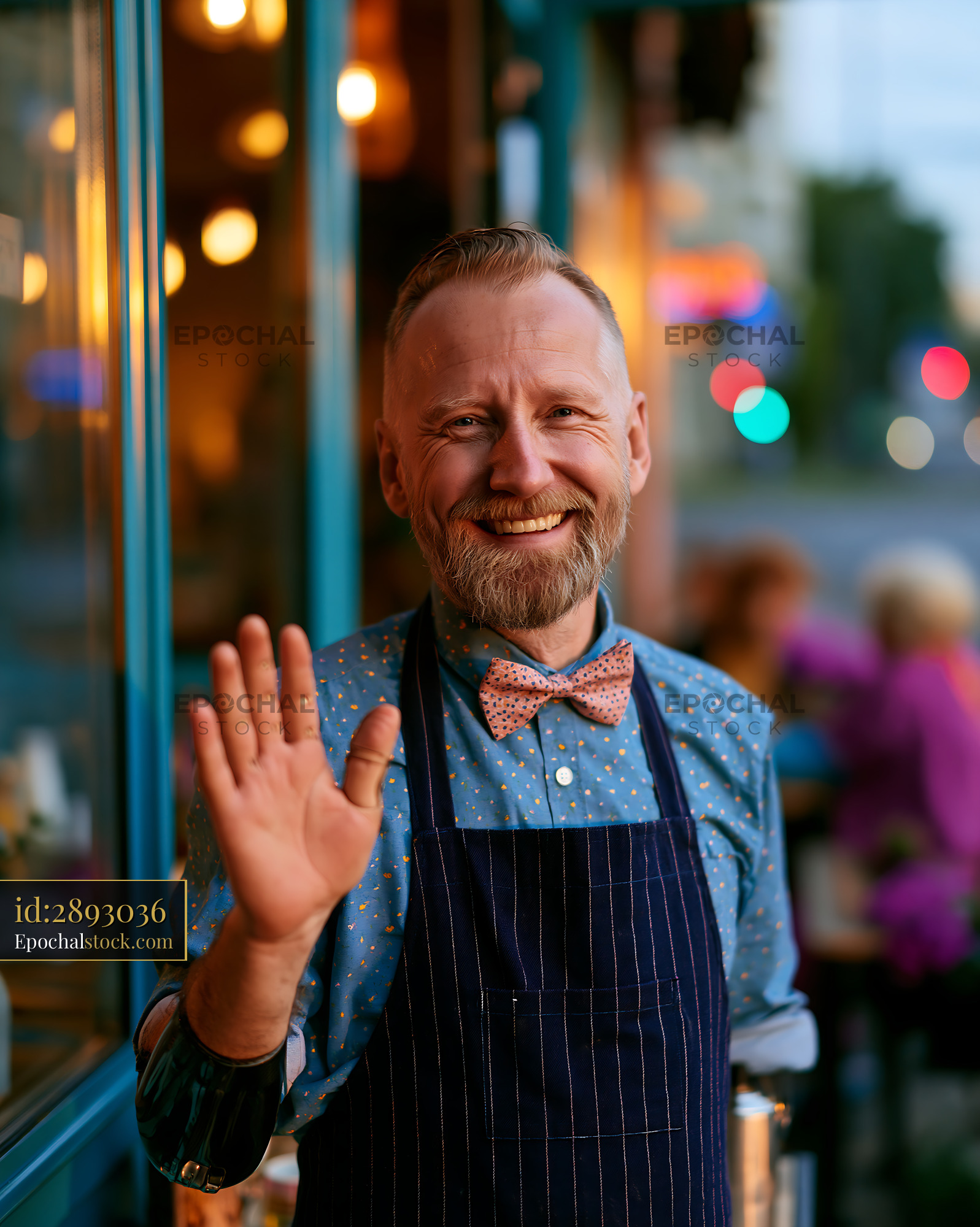 Watermarked full-resolution preview of Smiling man in an apron greets customers at a cafe