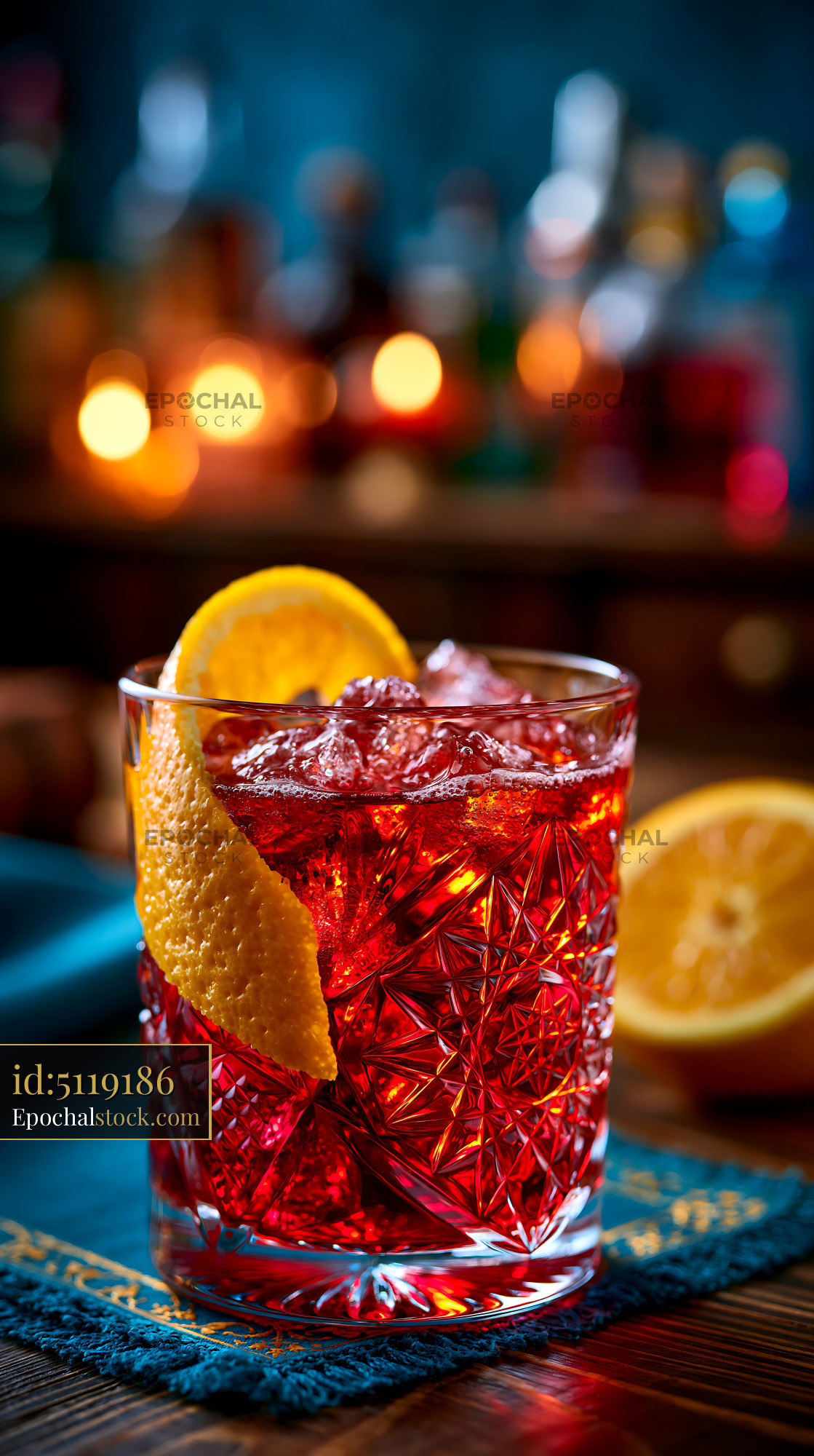 Watermarked full-resolution preview of Red cocktail with orange garnish in crystal glass