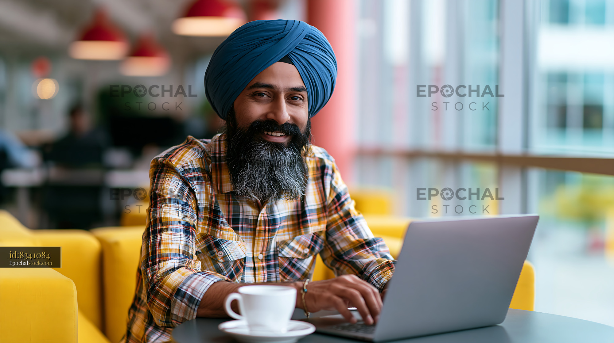 Sikh Consultant With Turban Working on Laptop in Modern Office - stock photo