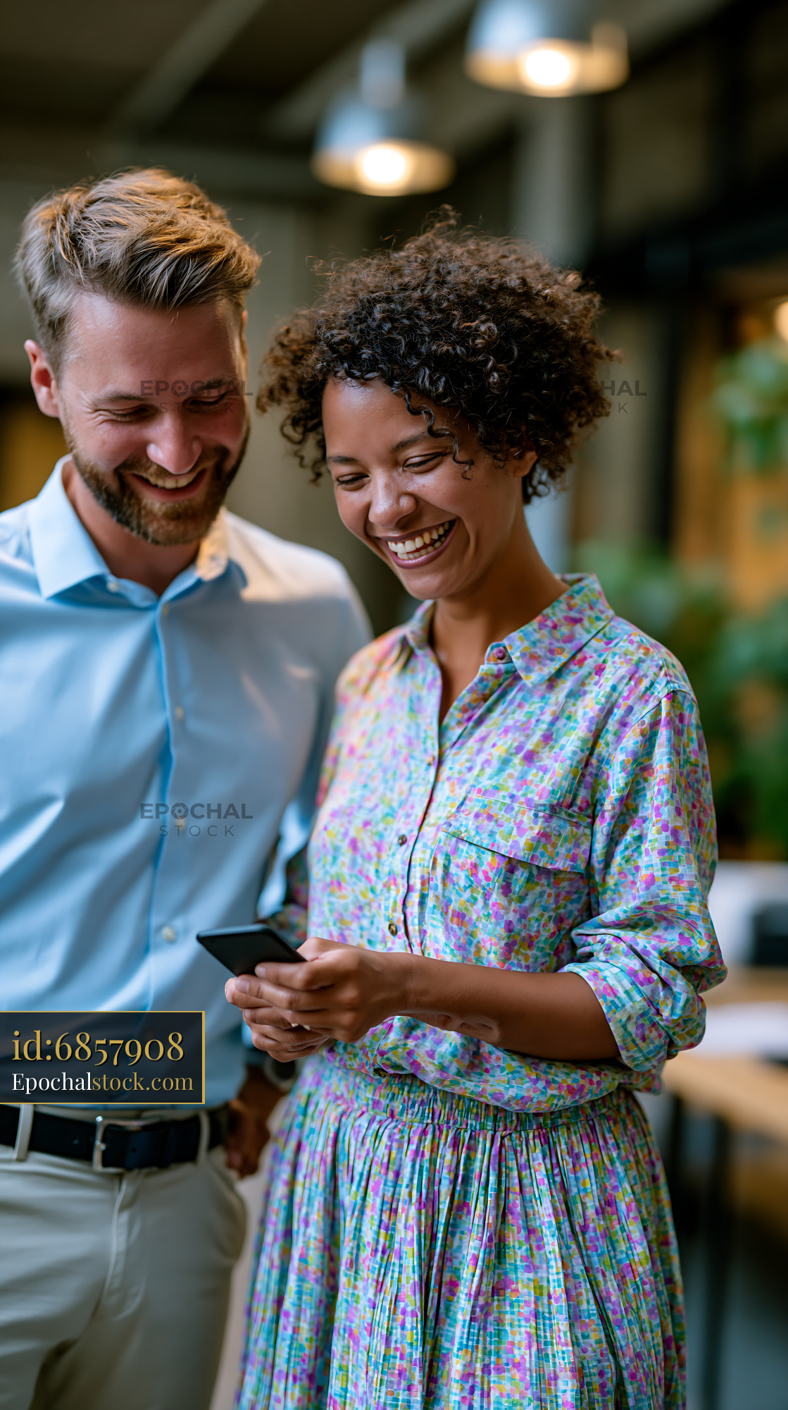 Watermarked full-resolution preview of Couple sharing a moment while looking at a phone in a cafe