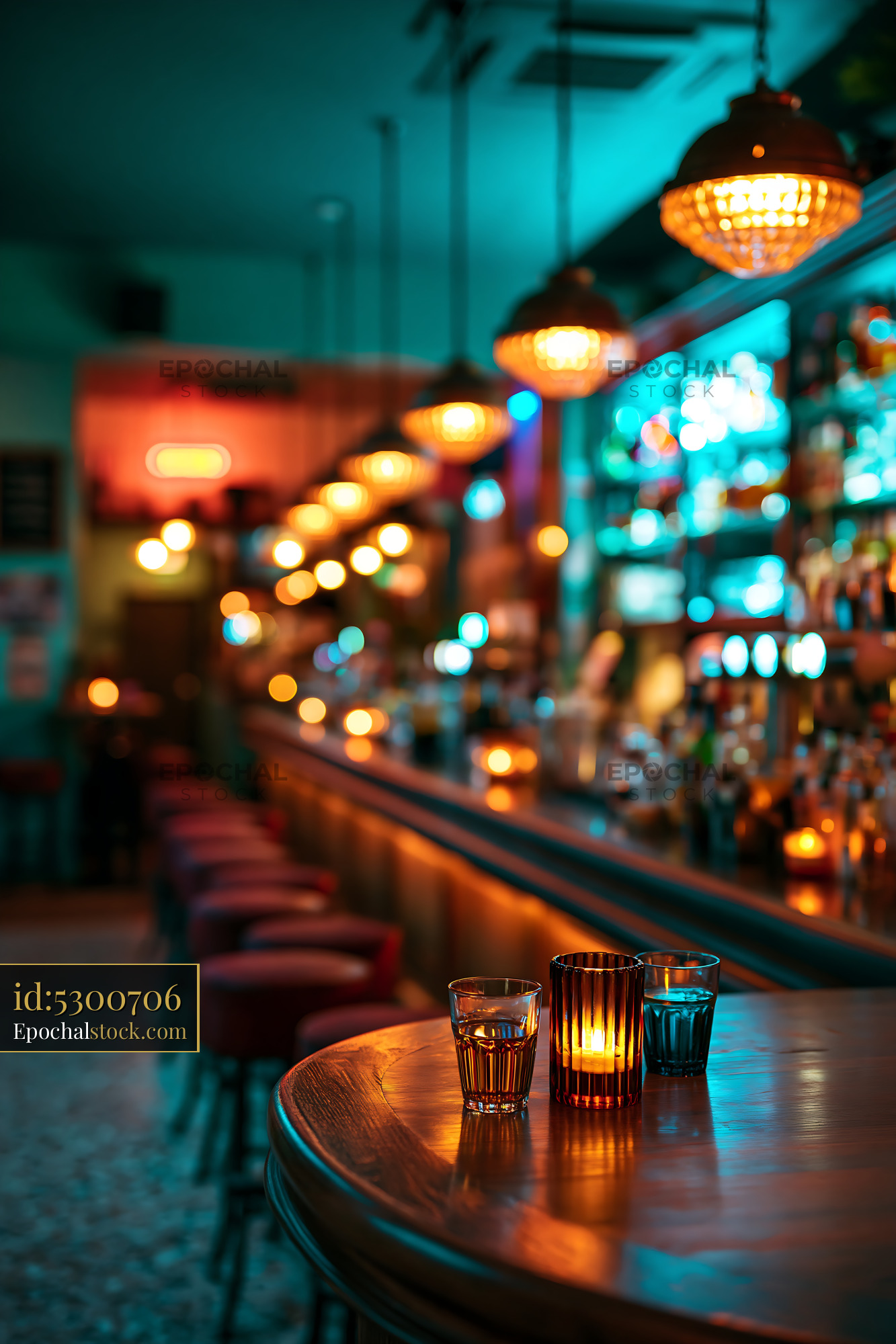 Bar Setting With Colorful Lights and Drinks on the Table - stock photo
