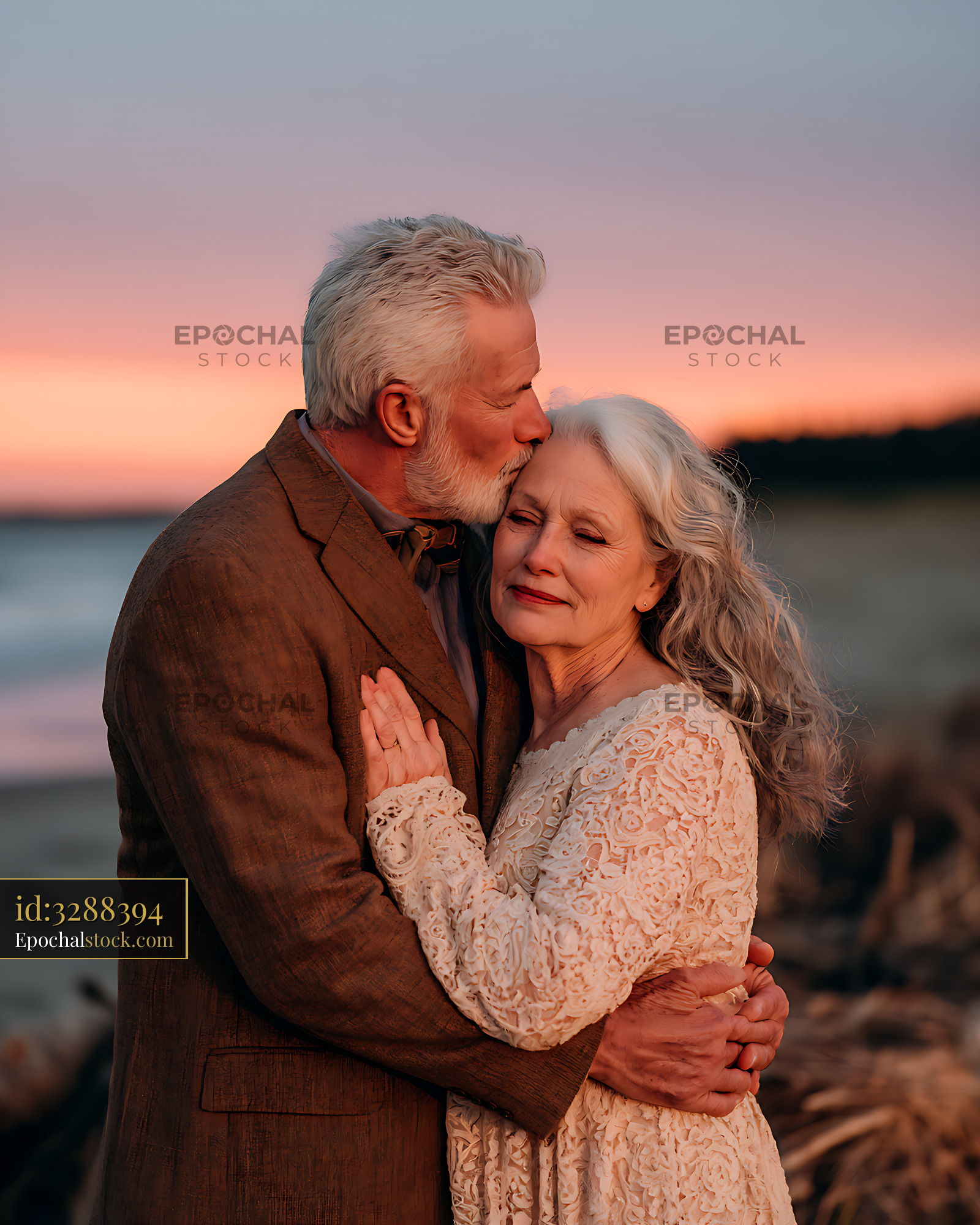 Watermarked full-resolution preview of Loving senior couple sharing an embrace at sunset