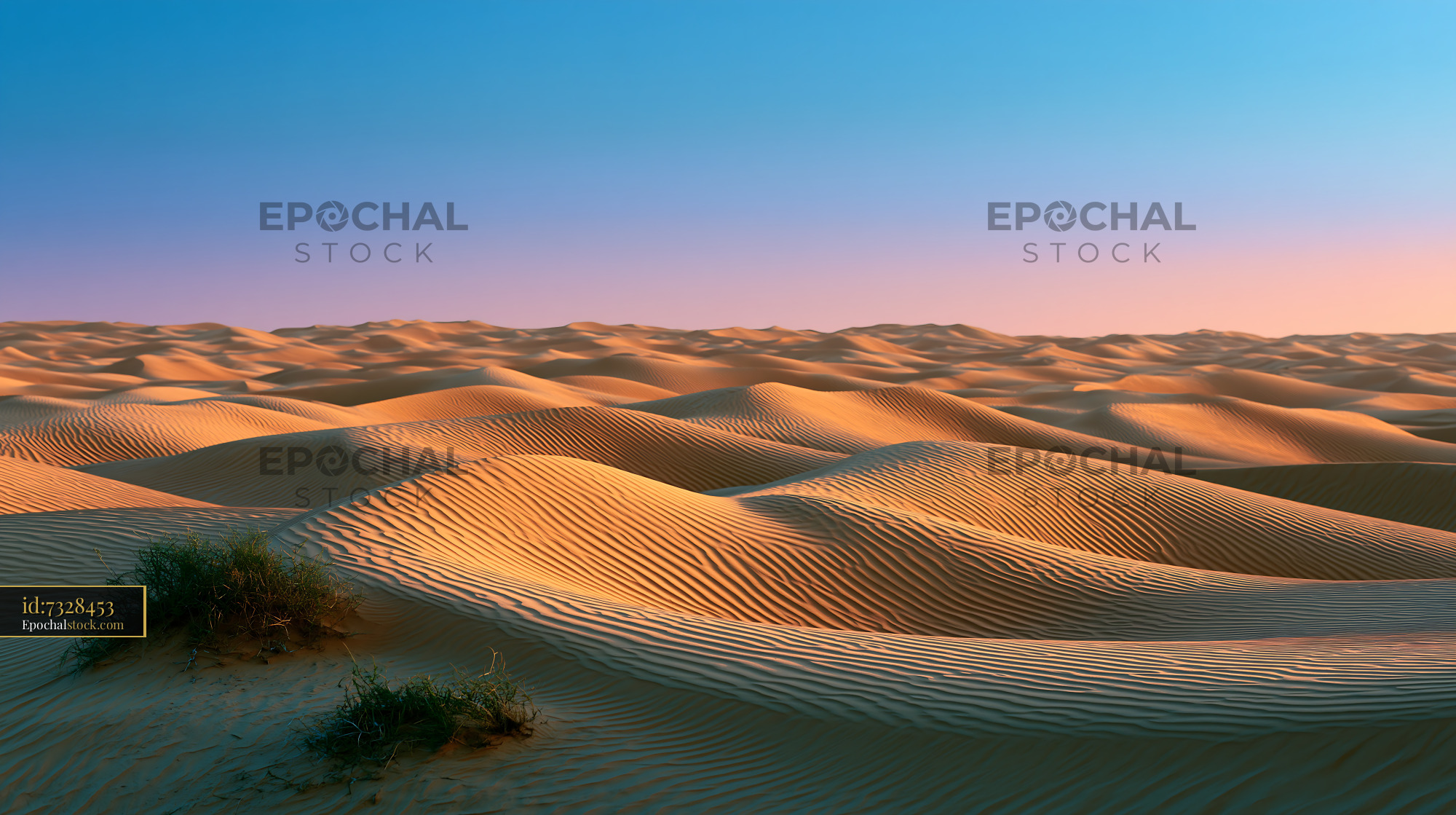 Watermarked full-resolution preview of Sand dunes under a blue sky at sunset in a desert landscape