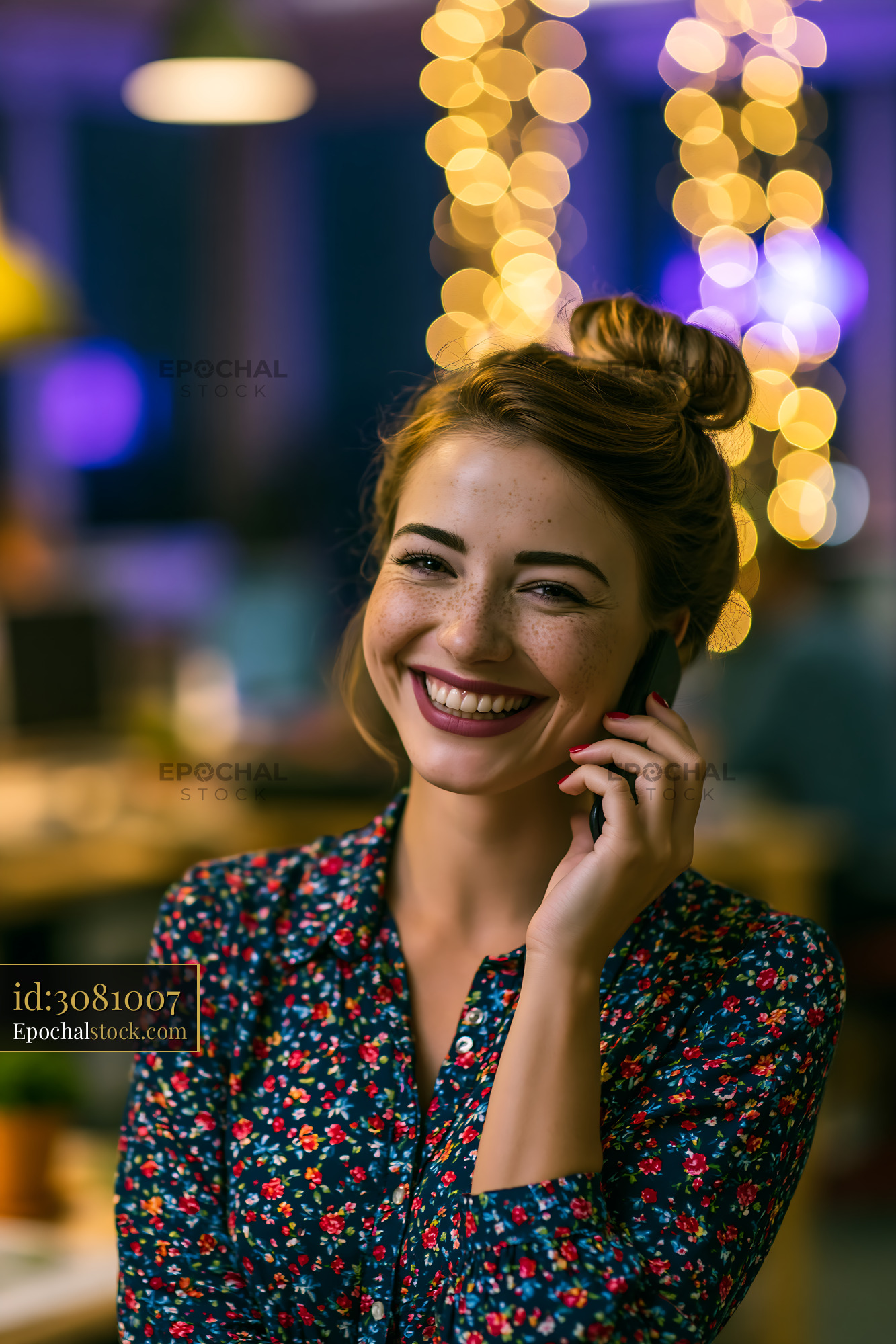 Watermarked full-resolution preview of Woman smiling on the phone with warm lights in background