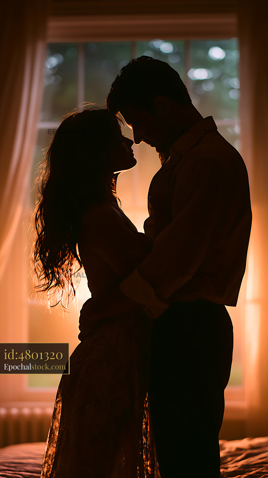 Watermarked full-resolution preview of Romantic couple silhouetted in warm window light