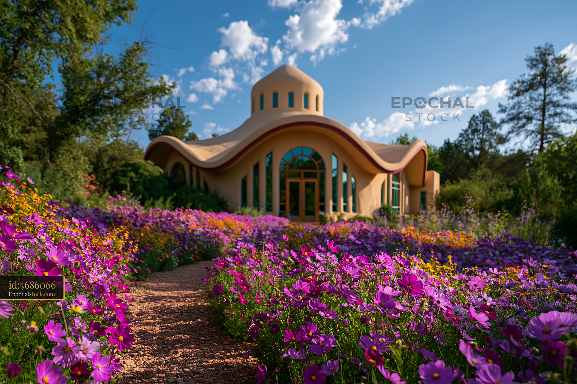 Watermarked full-resolution preview of Colorful flowers surround a unique house on a sunny day