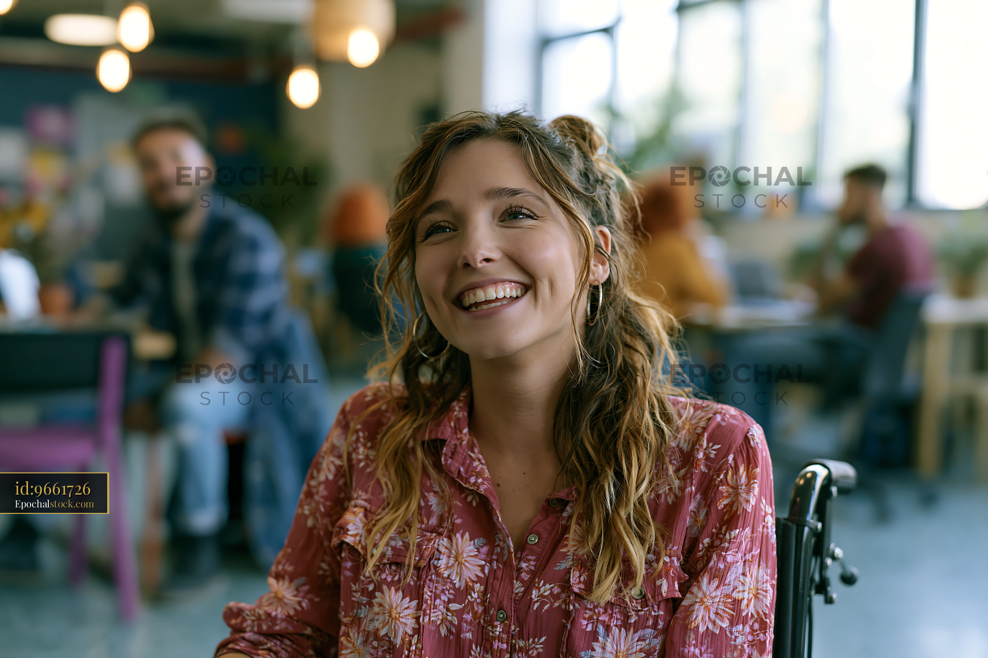 Watermarked full-resolution preview of Woman smiling in a modern cafe with people working around her