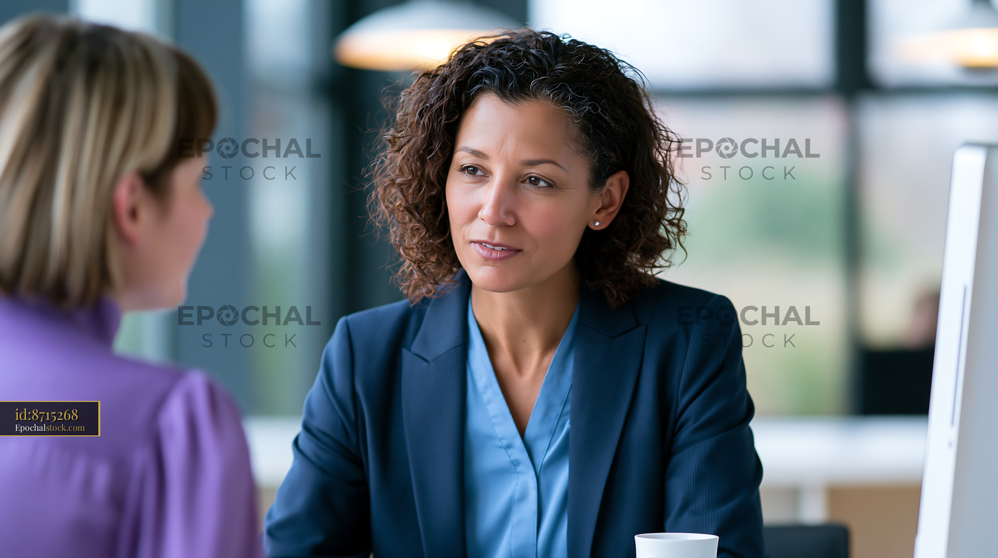 Watermarked full-resolution preview of Business meeting between two women in a modern office