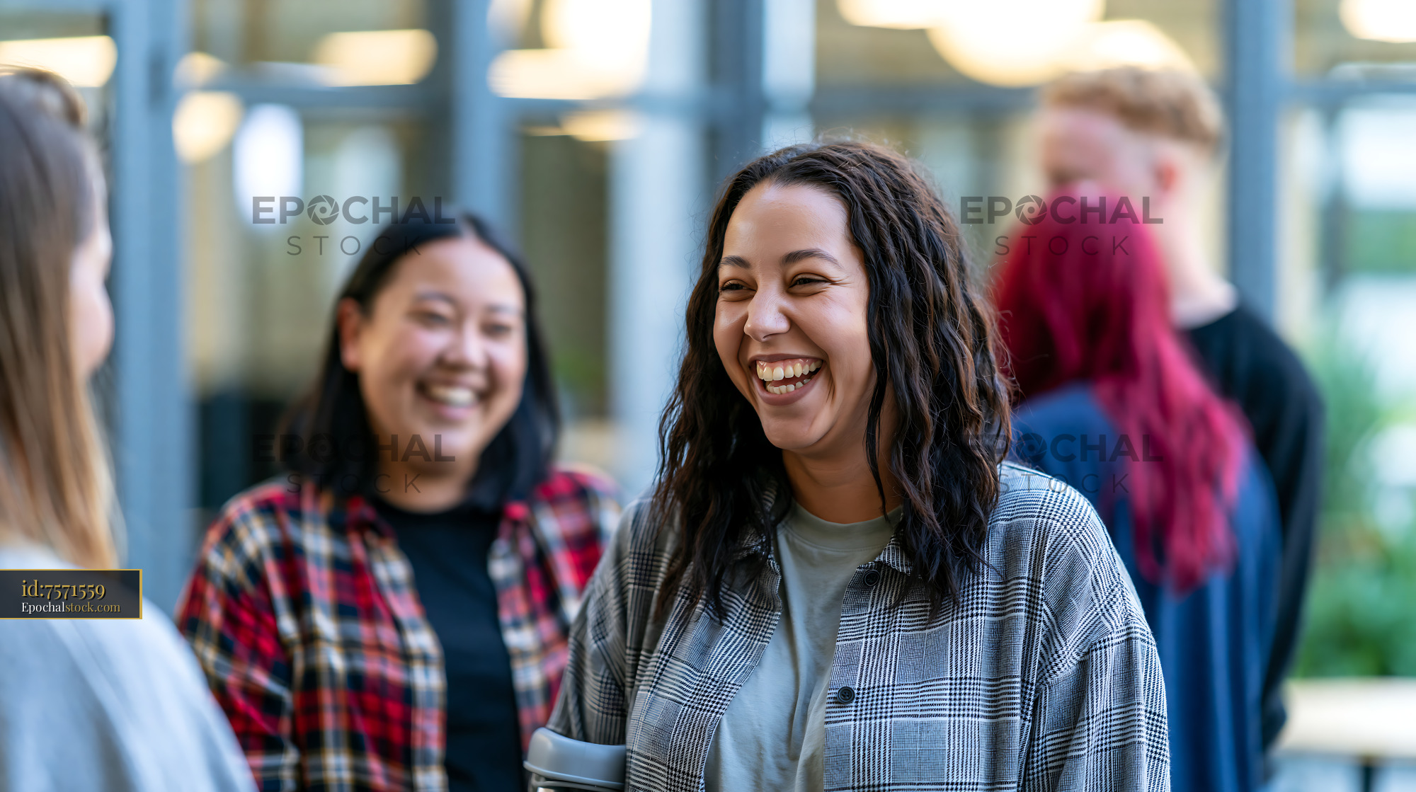 Watermarked full-resolution preview of Group of friends laughing and talking indoors at a social gathering