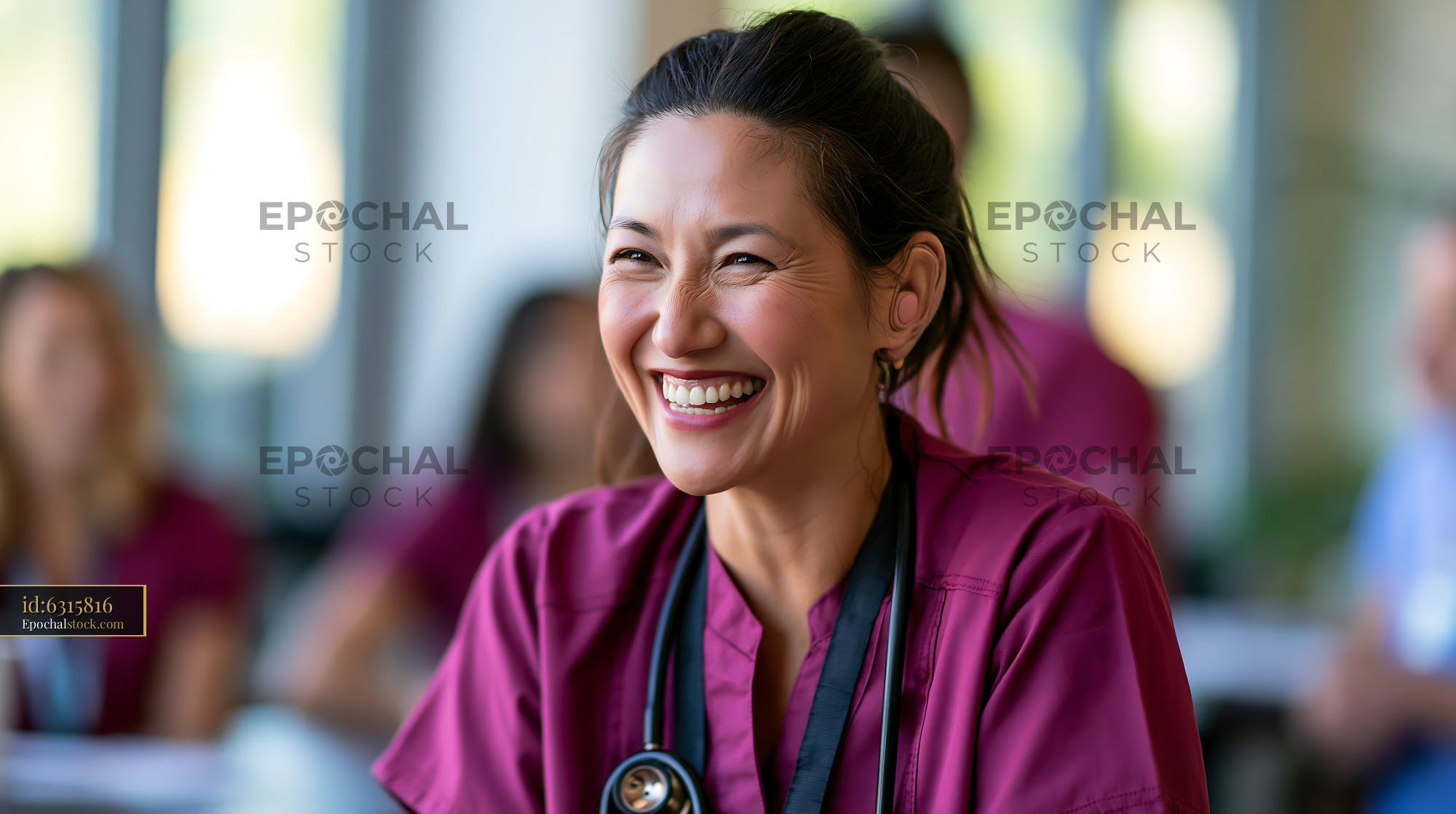 Laughing Nurse With Cochlear Implant in Bright Medical Setting - stock photo