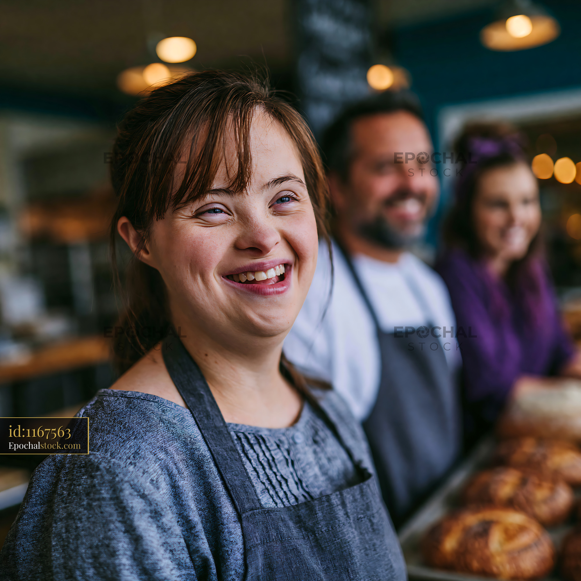 Watermarked full-resolution preview of Smiling woman in bakery with coworkers and freshly baked goods
