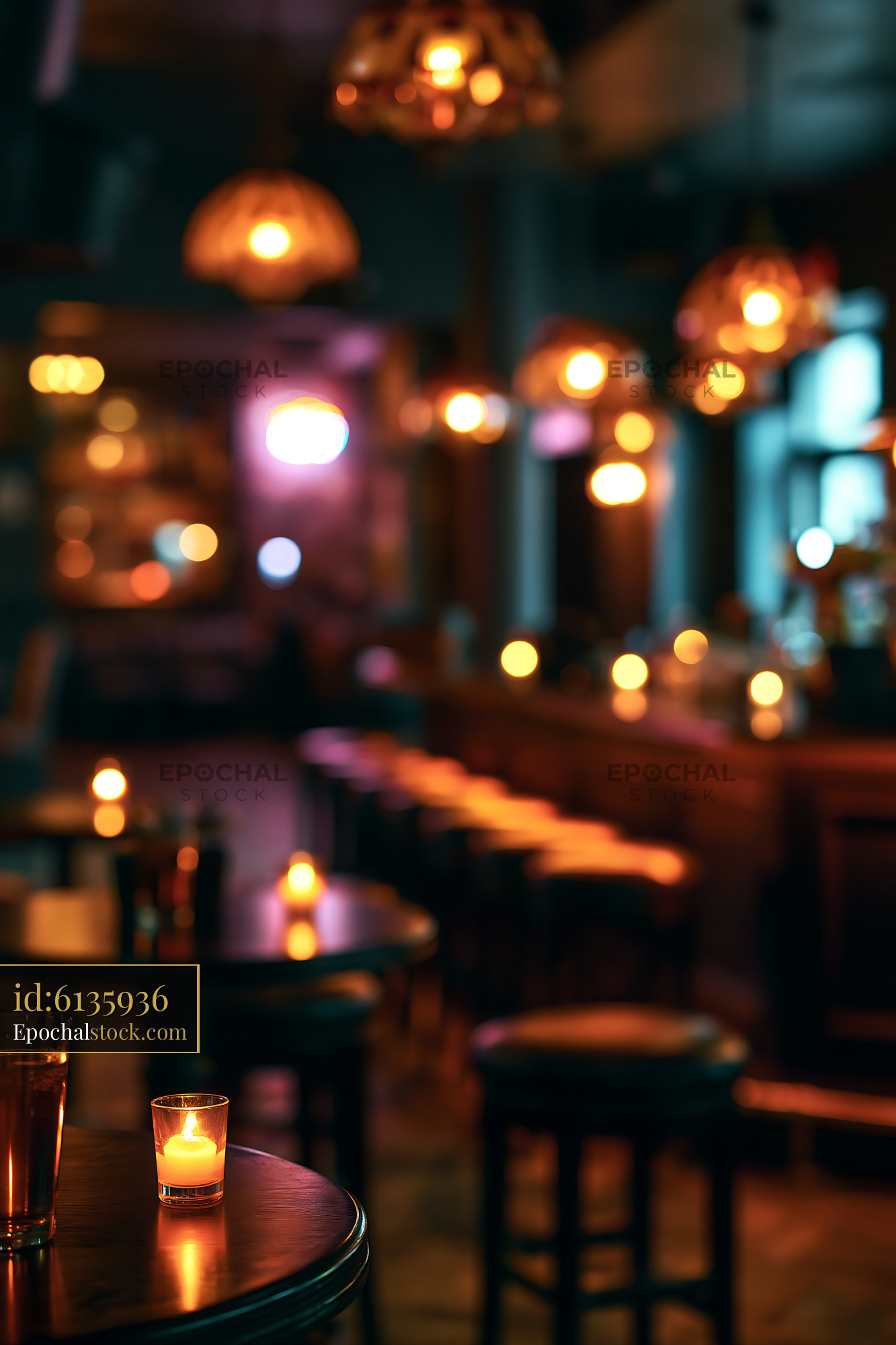 Cozy Bar Setting With Glowing Candles and Empty Stools at Night - stock photo