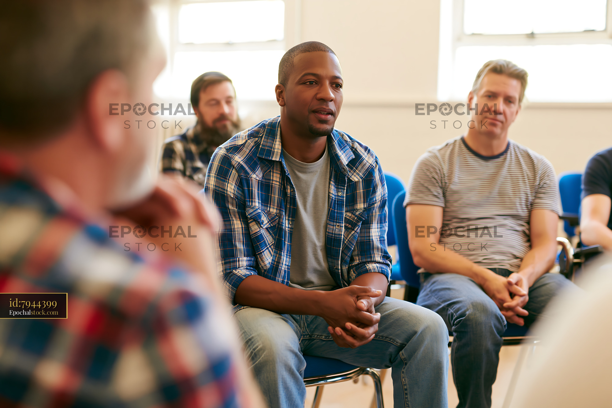Watermarked full-resolution preview of Group of men in discussion during a gathering indoors