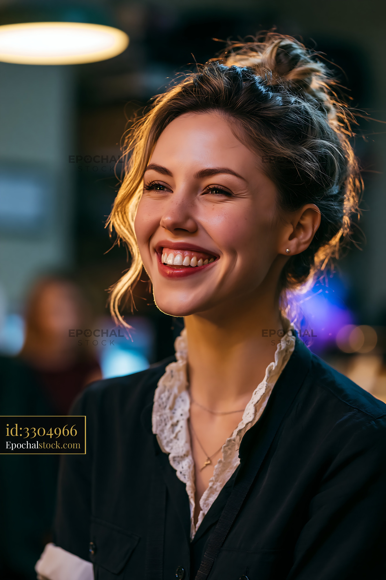 Smiling Woman Enjoys Conversation in Lively Indoor Setting - stock photo