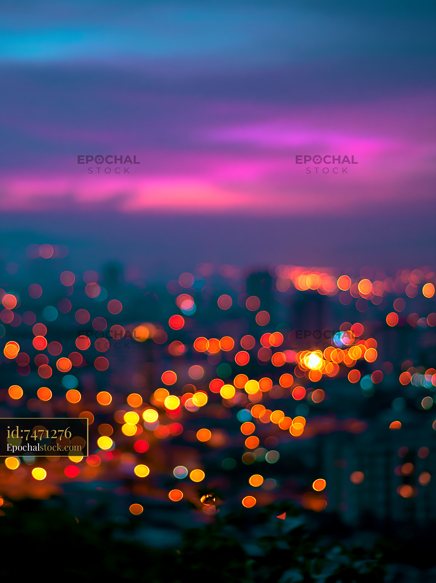 Watermarked full-resolution preview of City lights at dusk create a colorful scene in the background