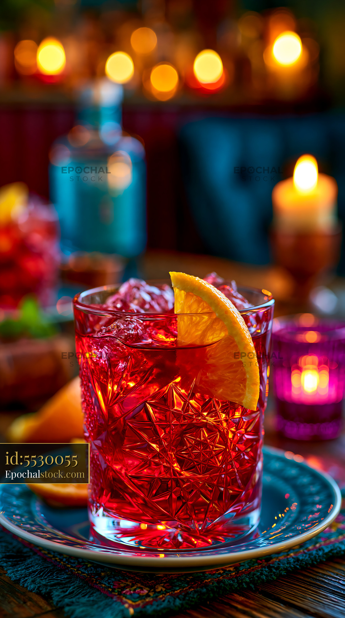 Watermarked full-resolution preview of Bright cocktail with orange slice placed on a table