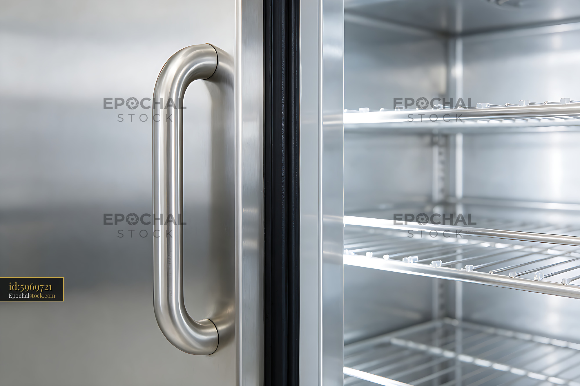Watermarked full-resolution preview of Open refrigerator with stainless steel handle and shelves