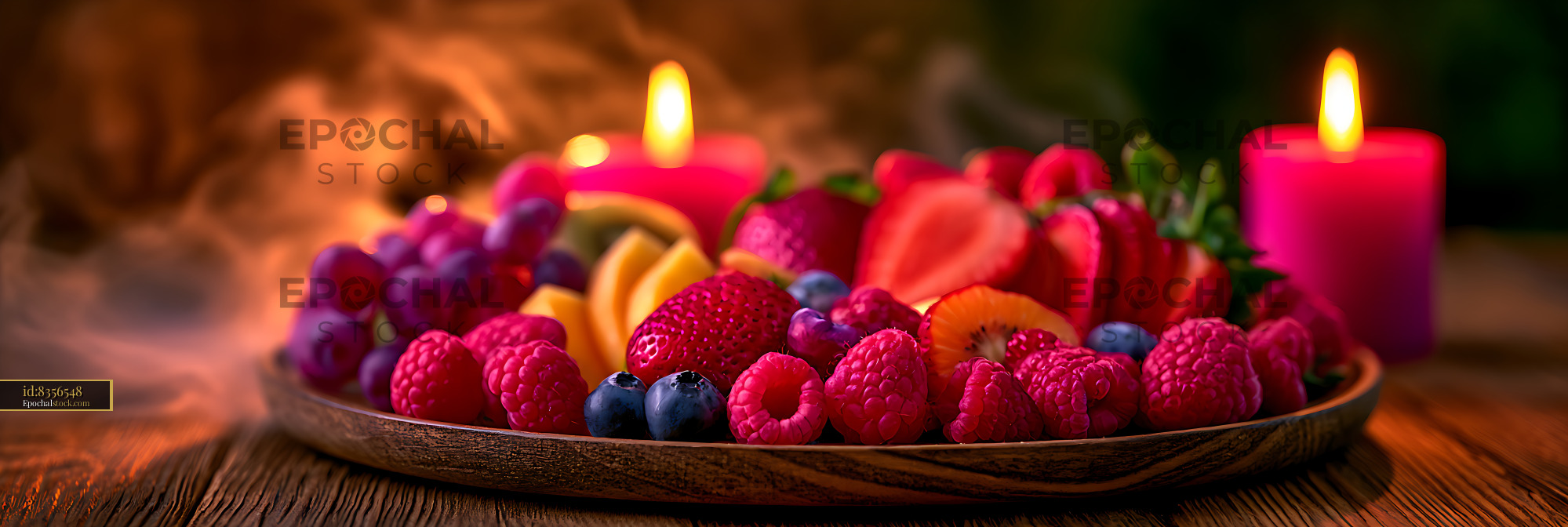Watermarked full-resolution preview of Colorful fresh fruit platter beside candlelight