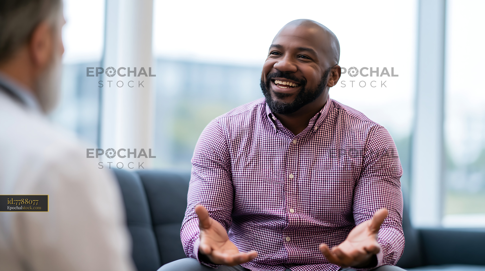 Watermarked full-resolution preview of Happy man having a conversation in a modern office