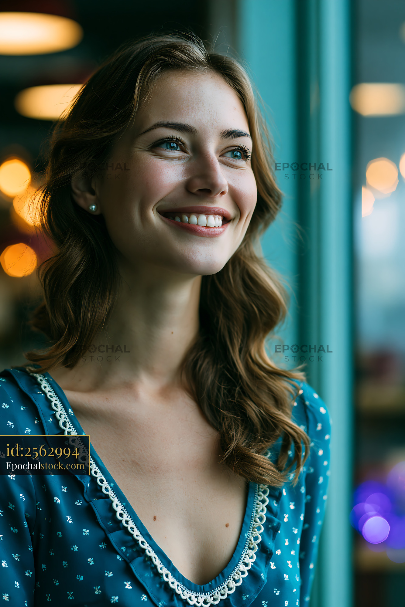 Watermarked full-resolution preview of Woman smiling by window with soft lighting in a cafe