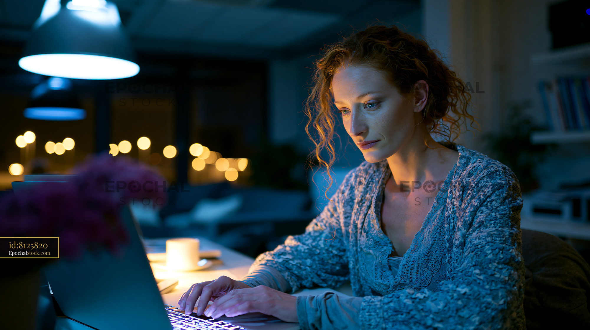 Watermarked full-resolution preview of Woman working late at night on a laptop in a cozy room
