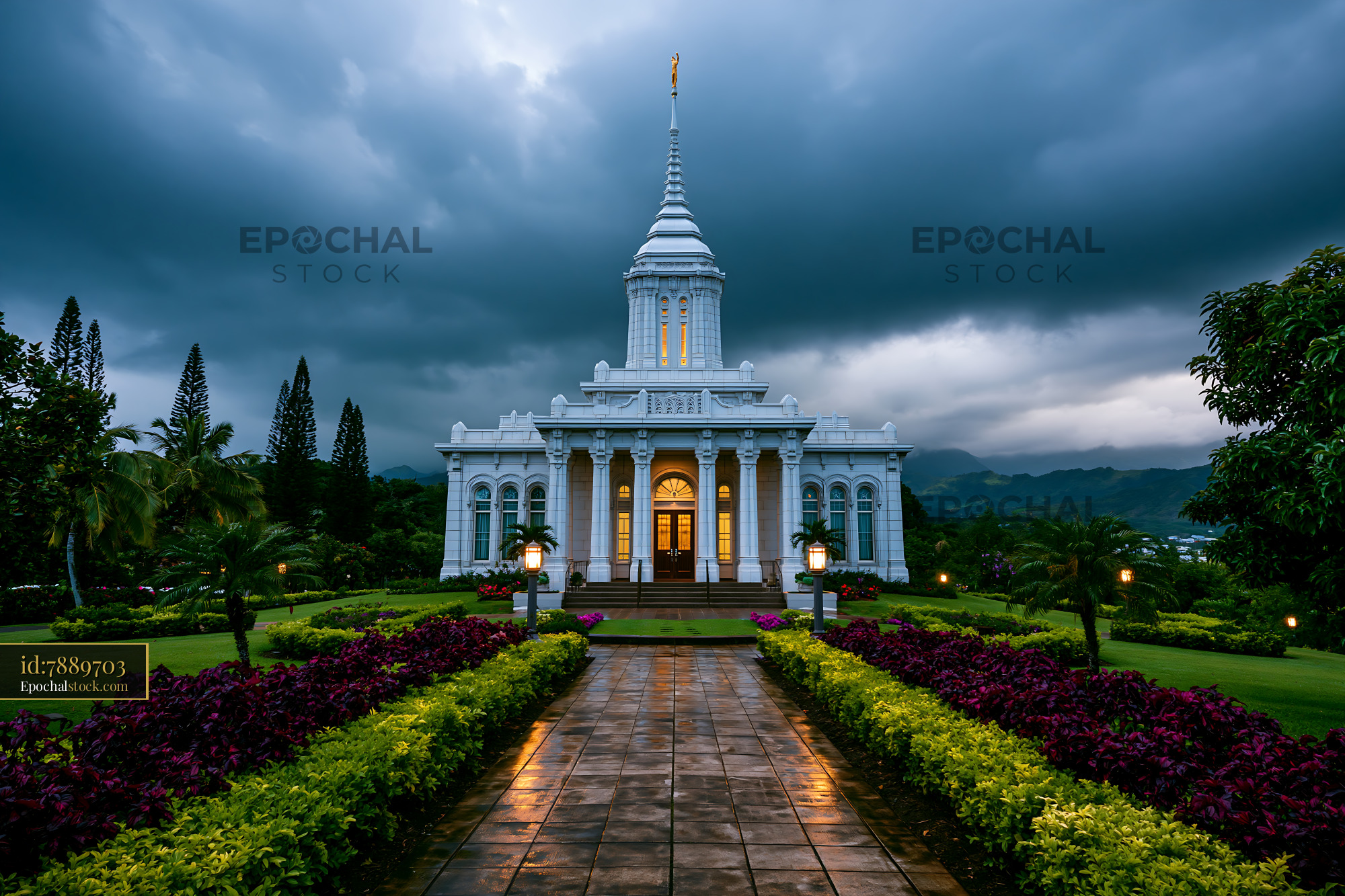 Watermarked full-resolution preview of Illuminated white temple in a tropical garden after rain