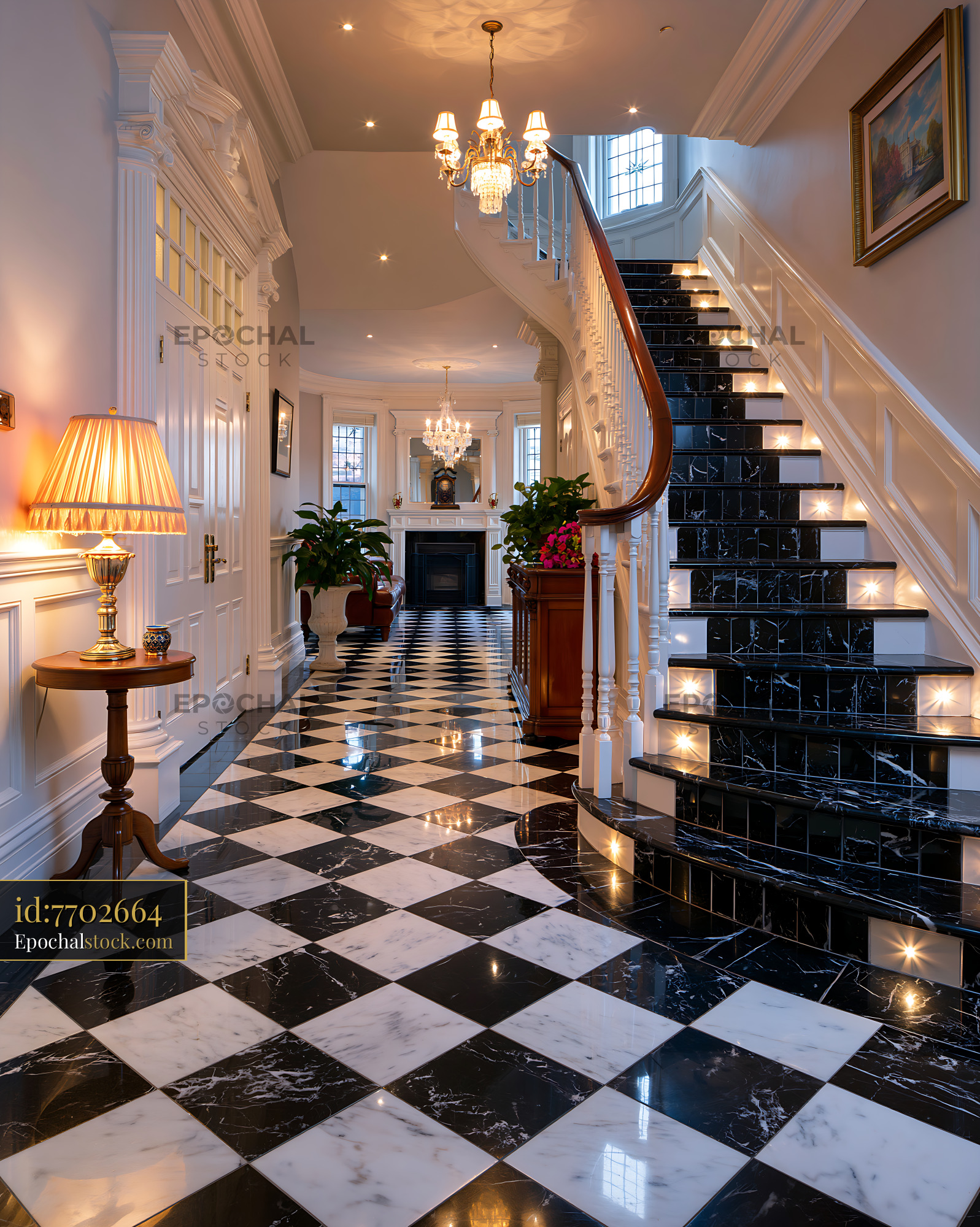 Marble Entrance Hall With Sweeping Staircase and Elegant Decor - stock photo
