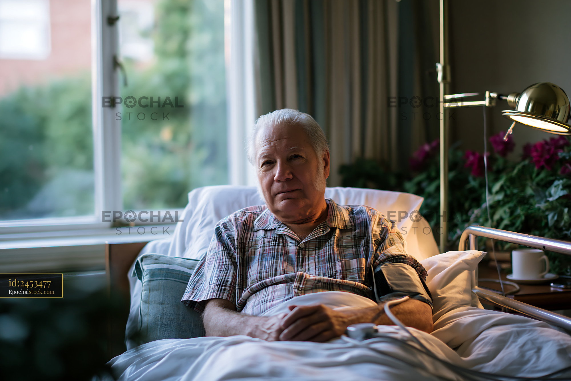 Watermarked full-resolution preview of Elderly man resting in bed with medical equipment nearby