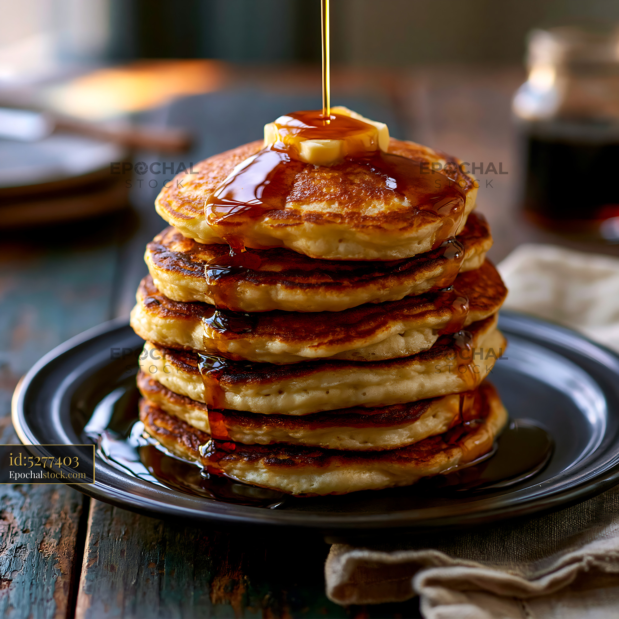 Watermarked full-resolution preview of Golden pancake stack with syrup and butter