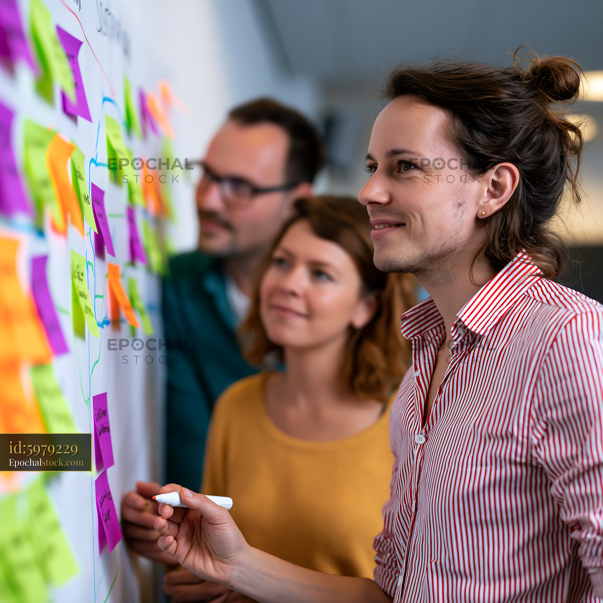 Watermarked full-resolution preview of Team members collaborate on brainstorming using sticky notes