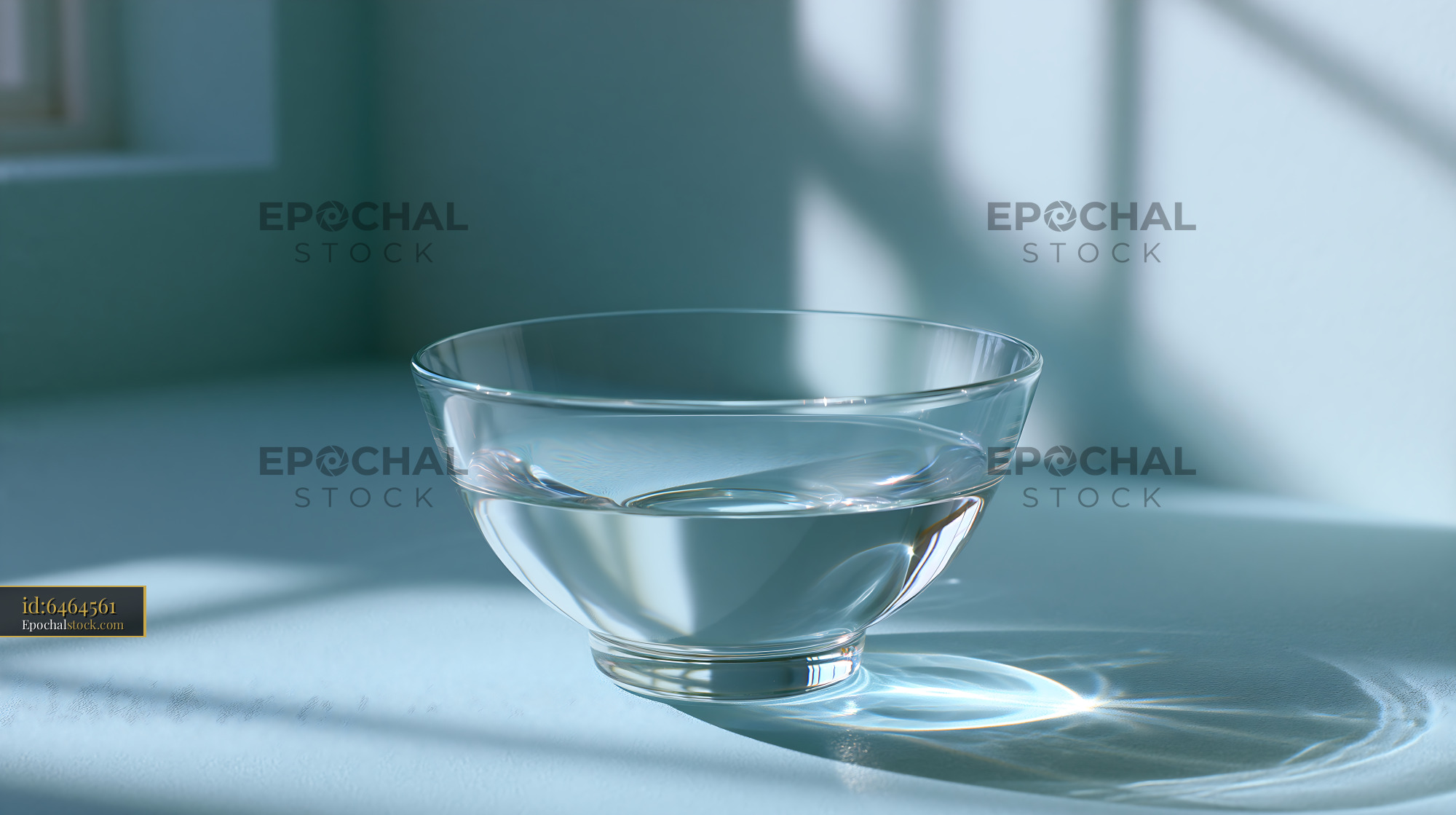 Watermarked full-resolution preview of Clear bowl with water on a table in sunlight