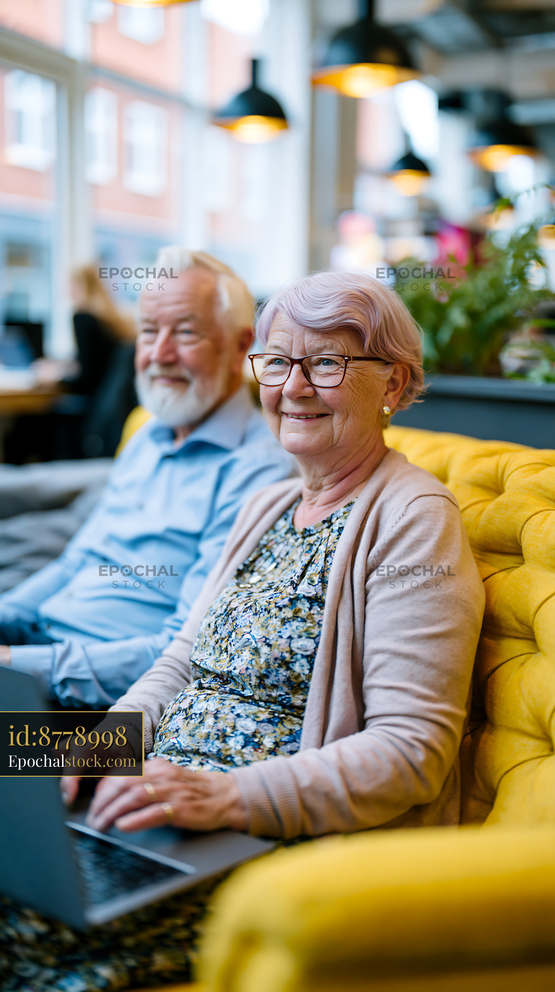 Watermarked full-resolution preview of Elderly couple sitting together in a cafe enjoying their time