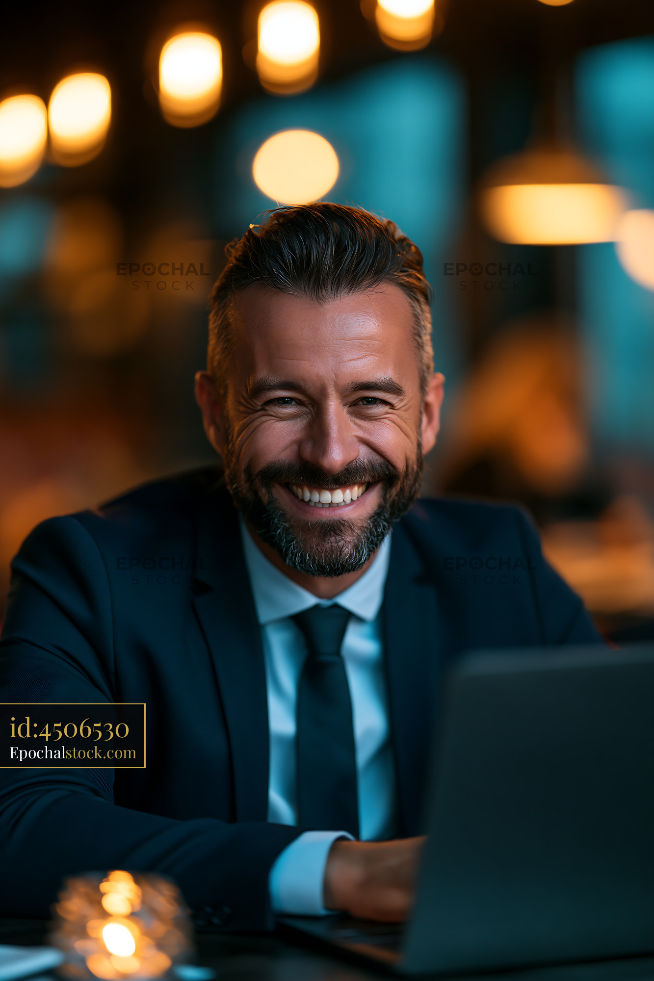 Watermarked full-resolution preview of Businessman smiling in a cafe during evening hours