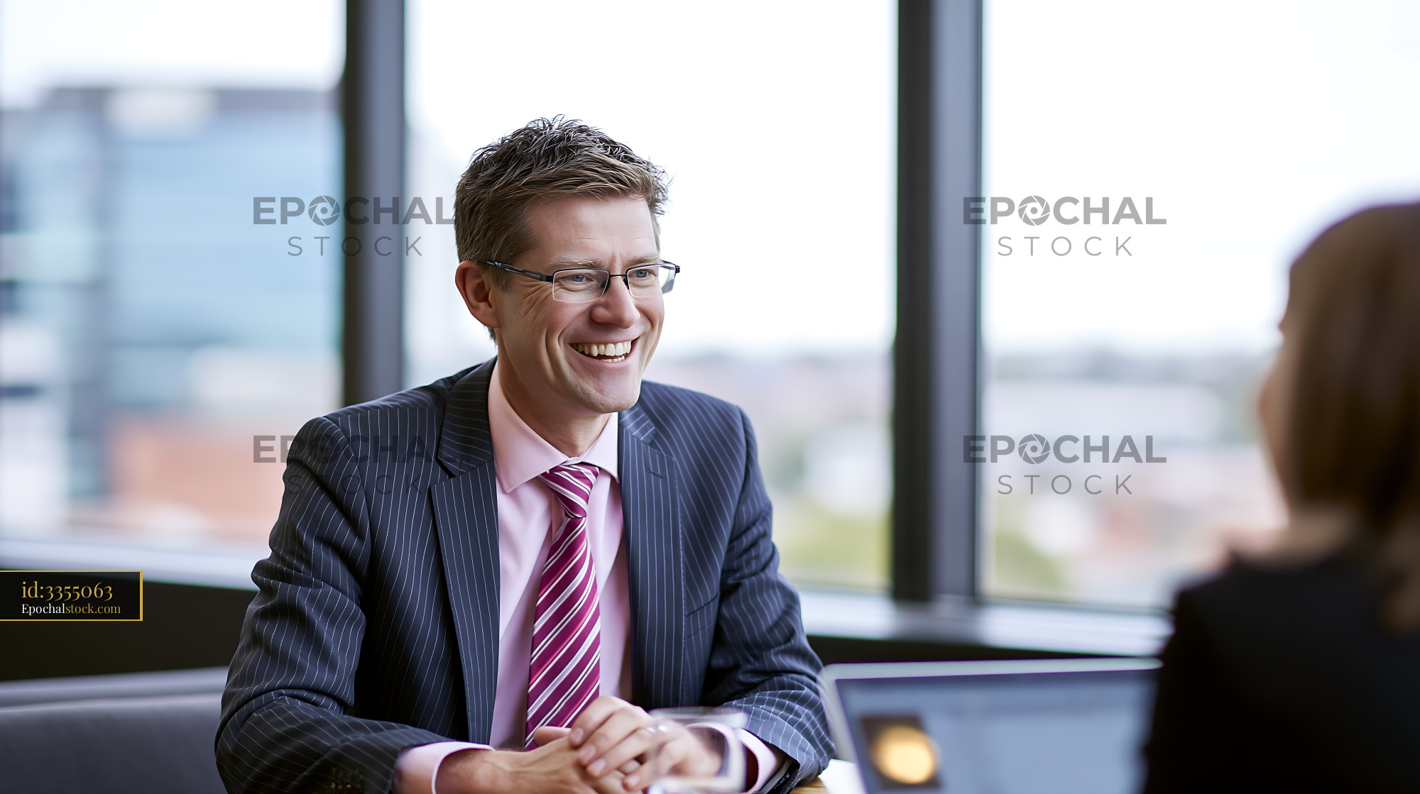 Watermarked full-resolution preview of Business meeting in an office with two professionals