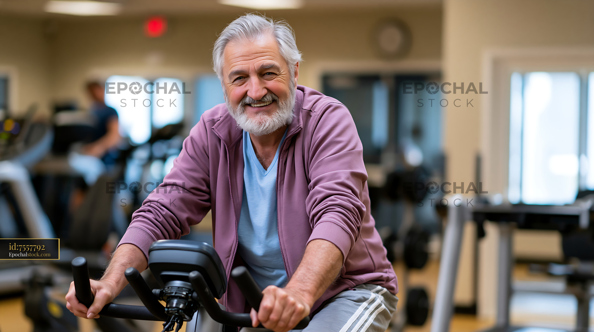 Senior Man Training on E-Bike in Gym Setting - stock photo
