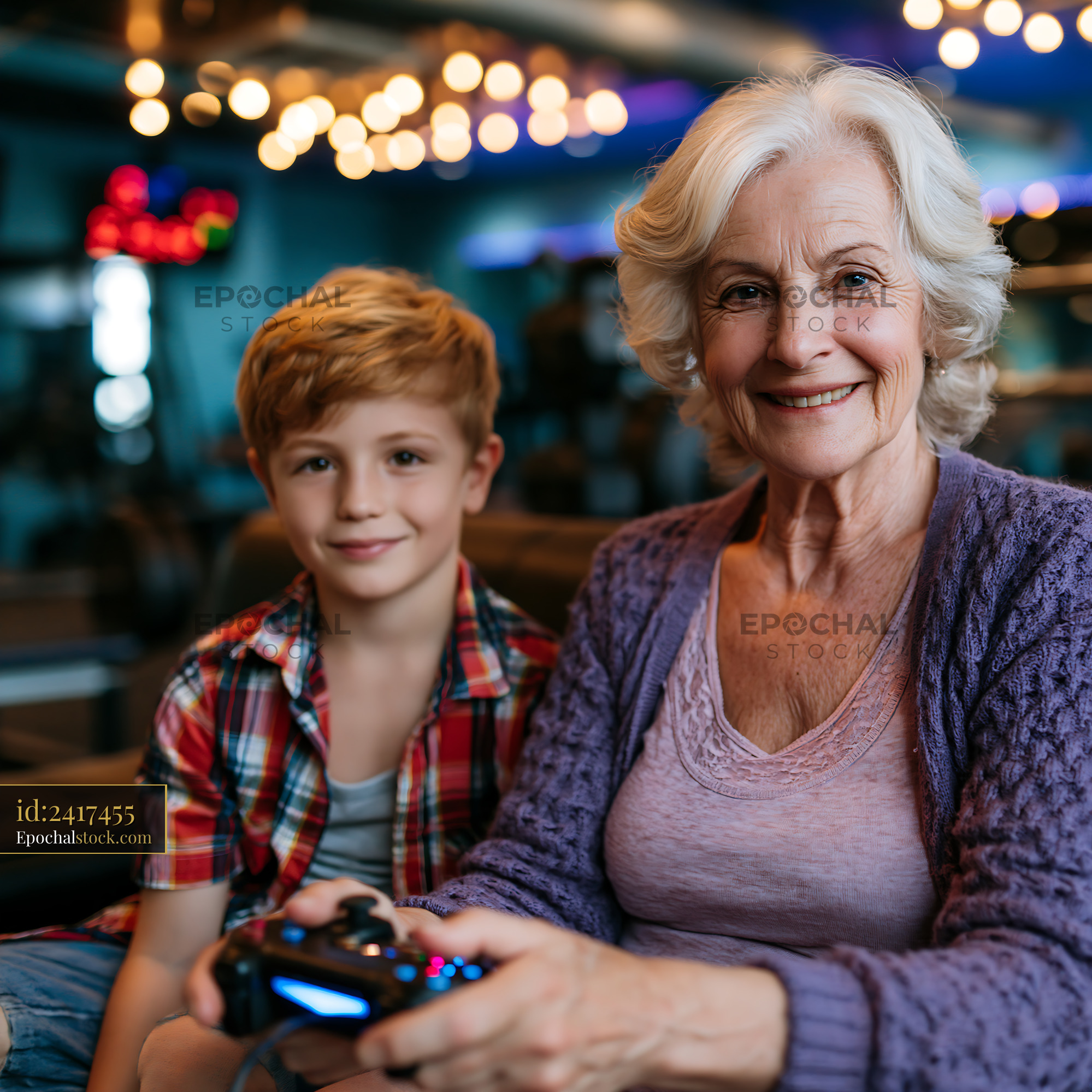 Watermarked full-resolution preview of Grandmother and grandson play video games together indoors