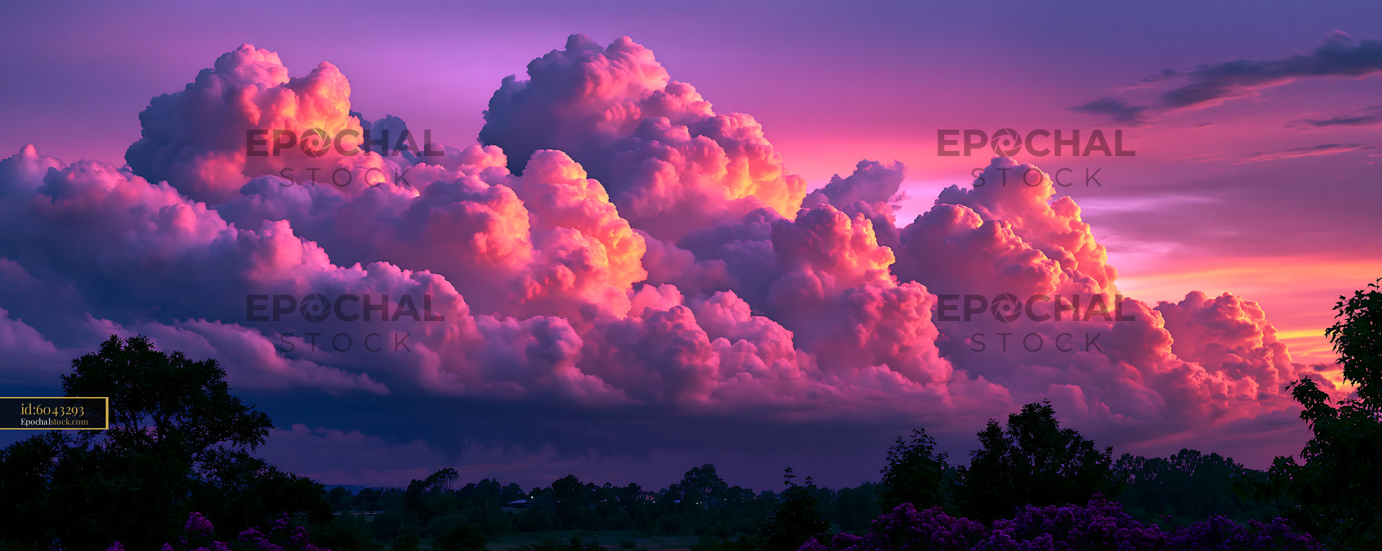 Watermarked full-resolution preview of Colorful clouds at sunset over a landscape