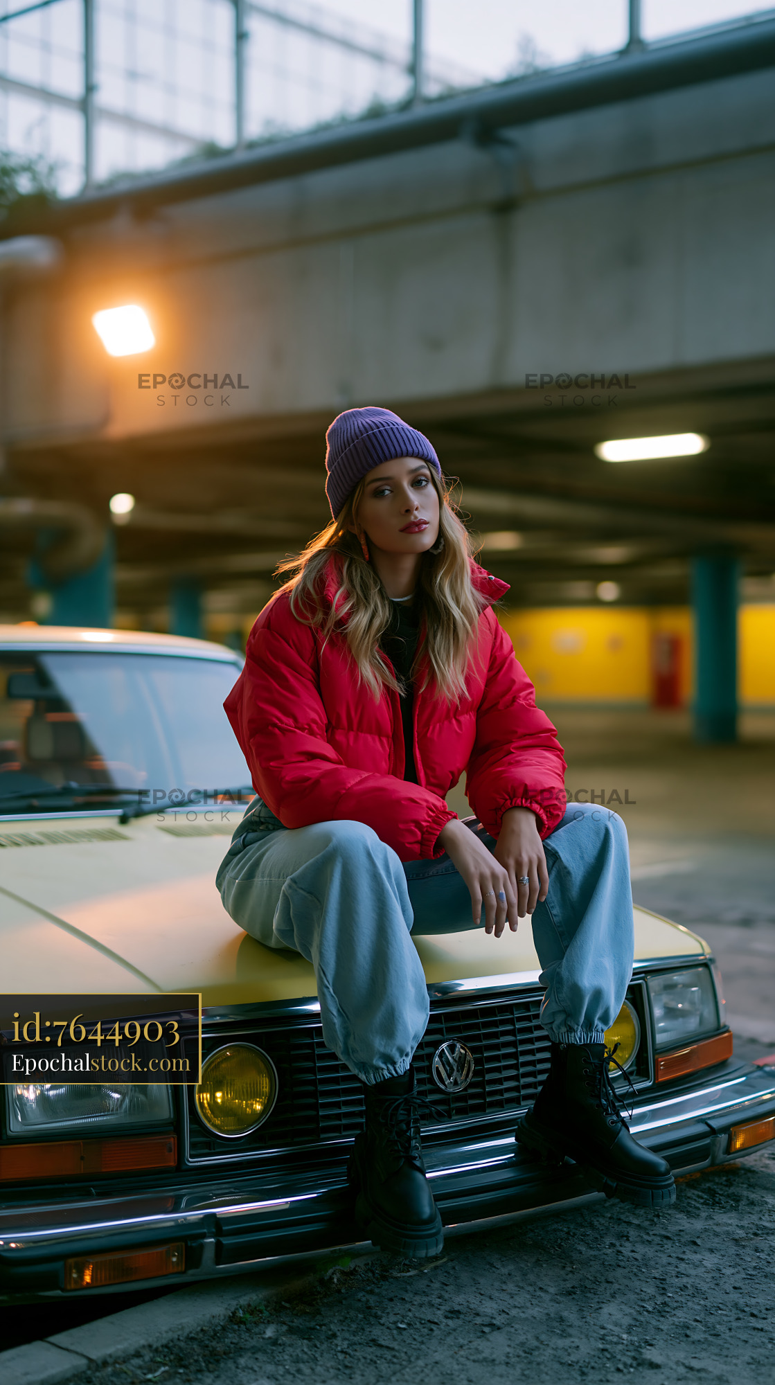 Watermarked full-resolution preview of Girl sitting on a yellow car in a parking garage at night